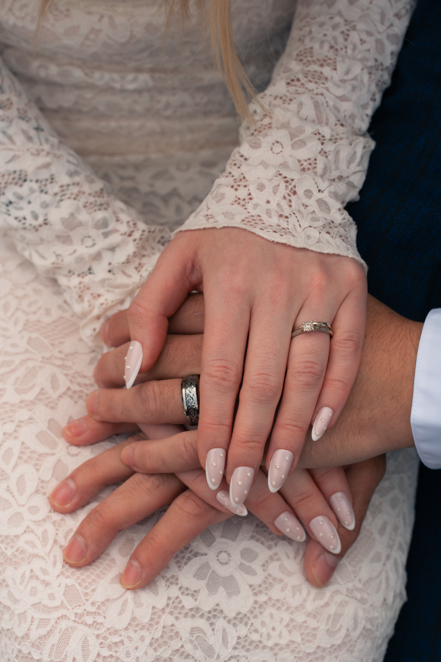 Aberdeen wedding photography: Detail shot of rings; hands loosely clasped; bride's polkadot nails are visible.