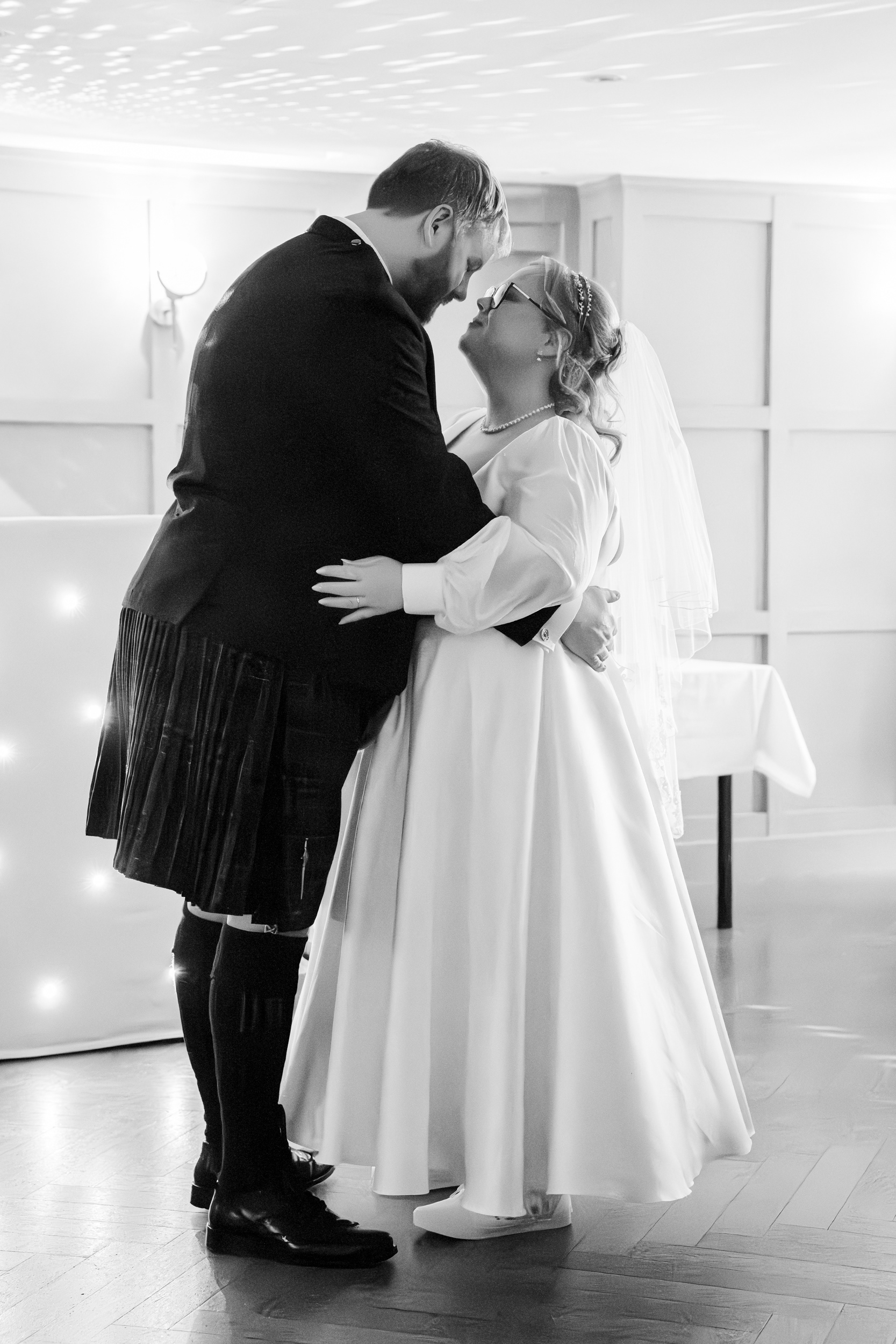 Aberdeen Palm Court wedding: Black and white photo of bride and groom dancing.