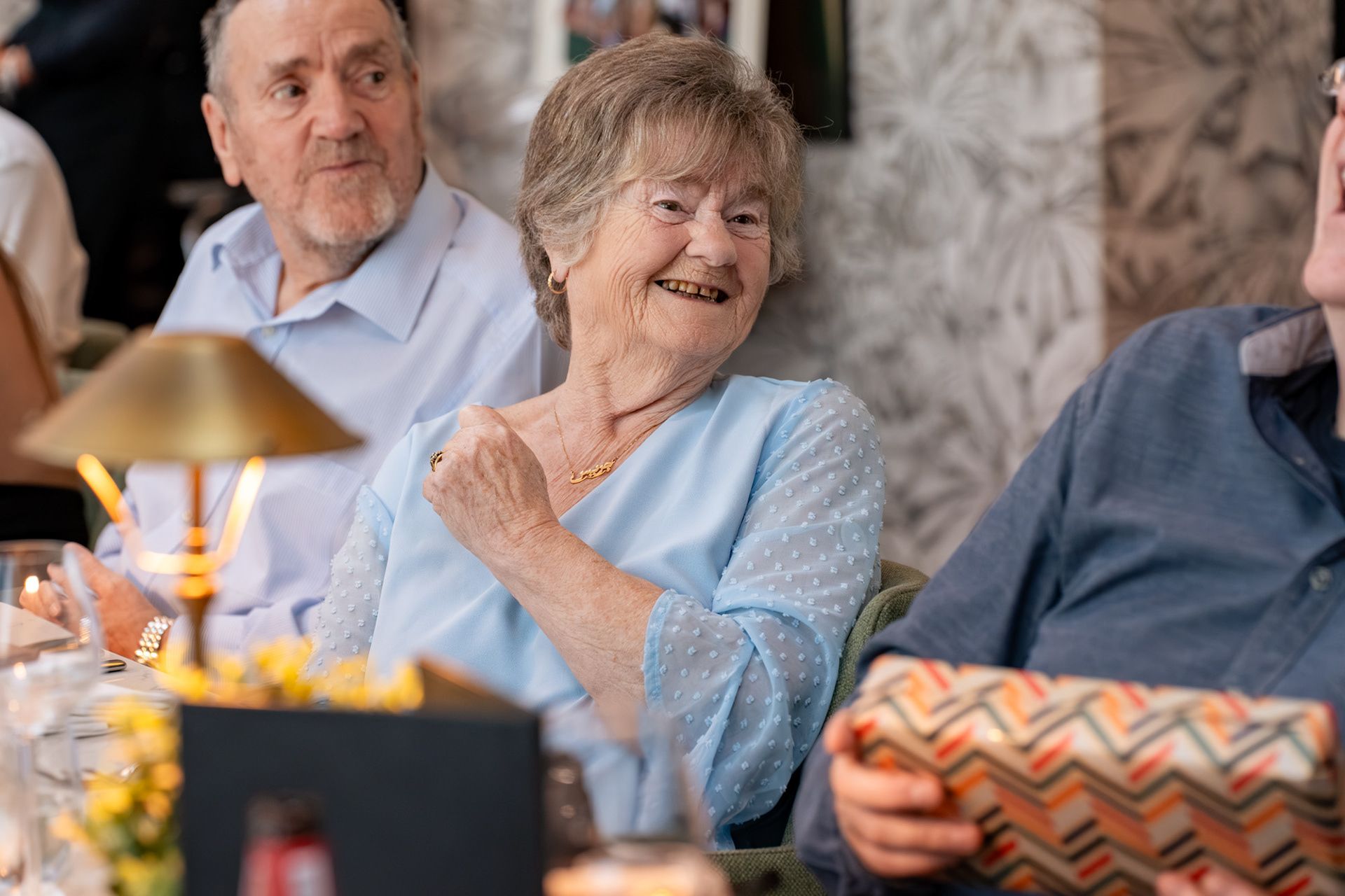 Aberdeen Photographer: A grey-haired woman in a pale blue top laughs.