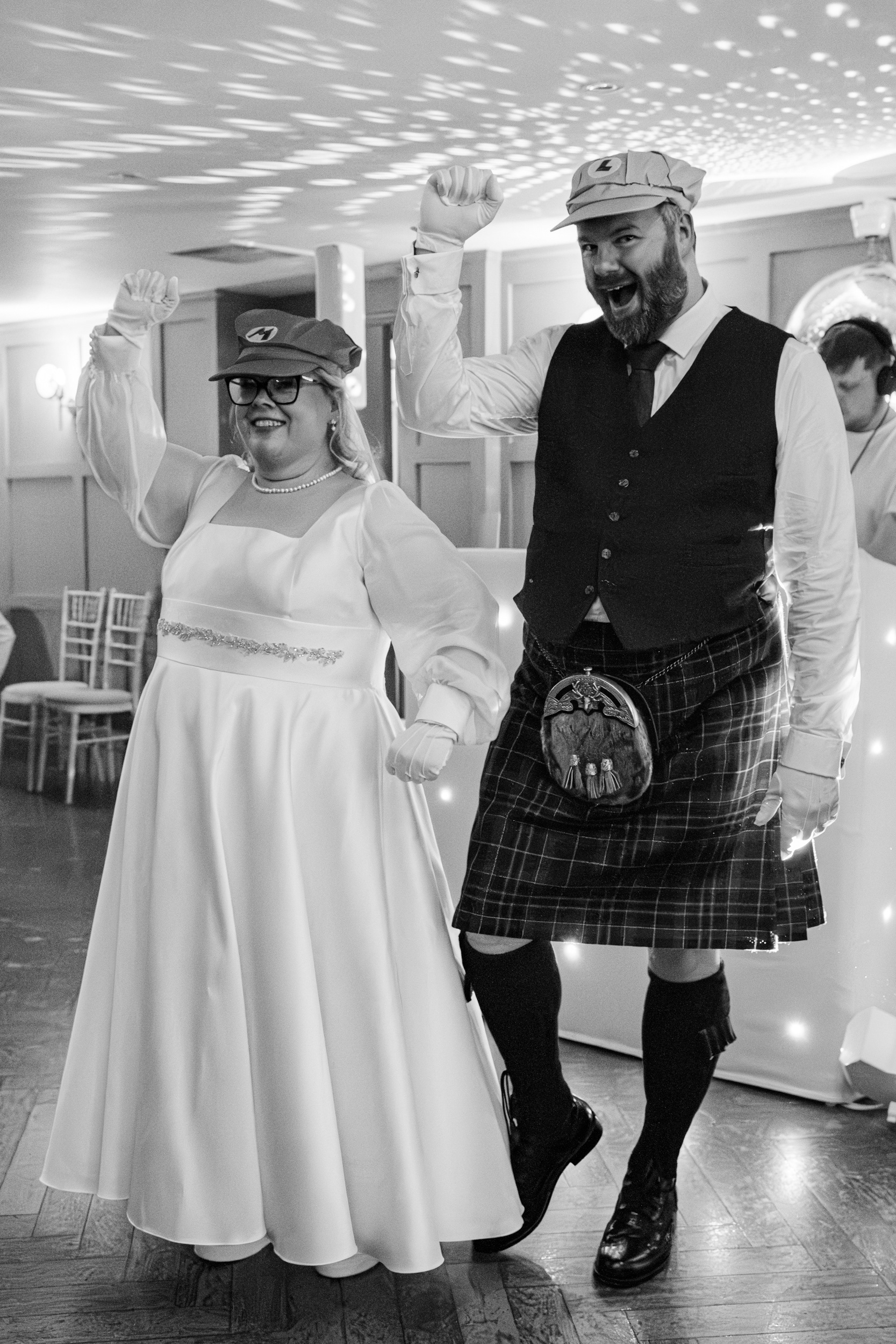 Alternative Aberdeen wedding, gamer theme: Bride and groom wear Mario and Luigi, Super Mario, caps and jump for the camera.