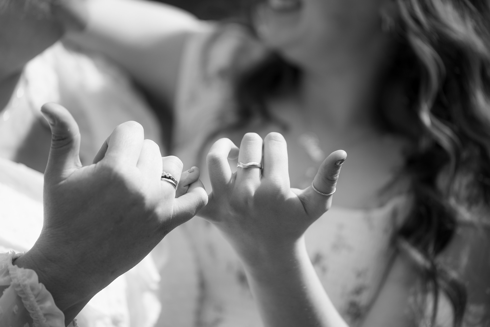 Black and white close up of mother and daughter's hands doing a pinky promise during their Aberdeen family photo shoot.