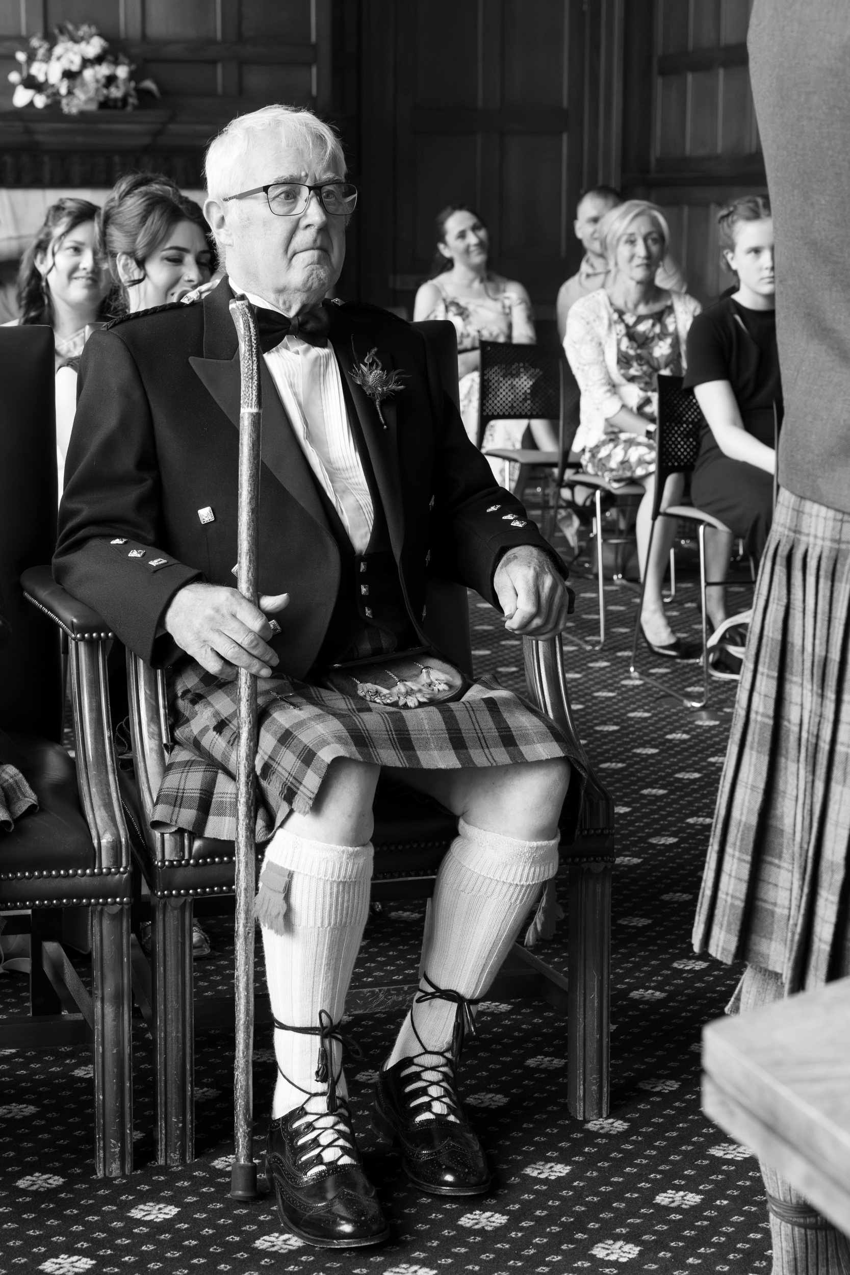 Aberdeen registry office wedding: Black and white photo of a father in kilt looking overwhelmed at his child's wedding.