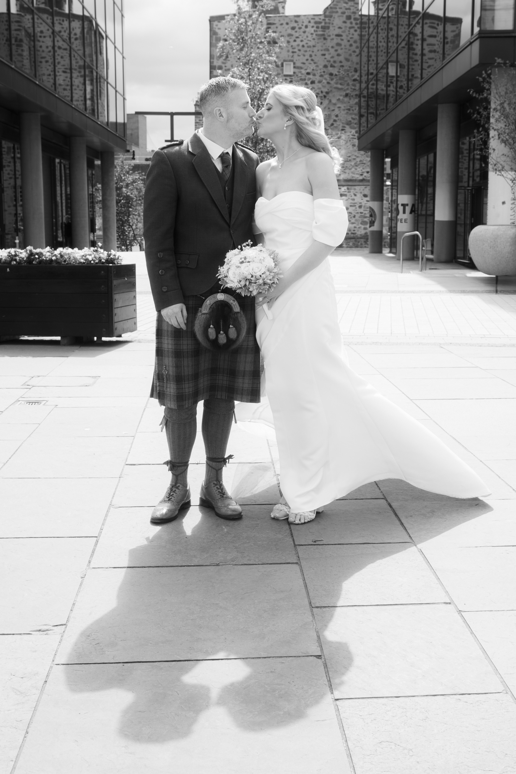 Aberdeen registry office wedding: Bride and groom kiss on Broad Street.
