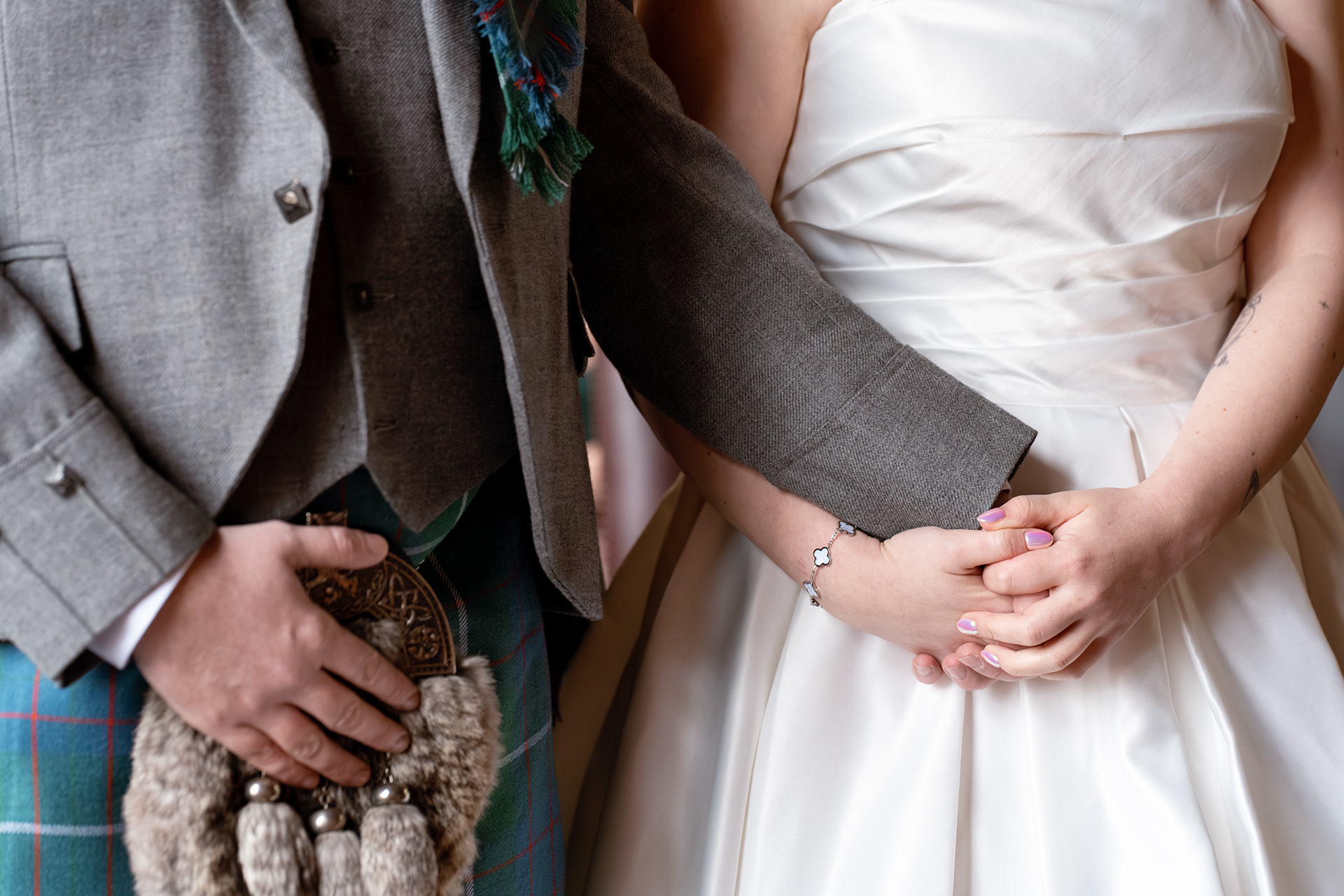 Aberdeen wedding: close up of brides hands clasping groom's hand at the start of their wedding ceremony.