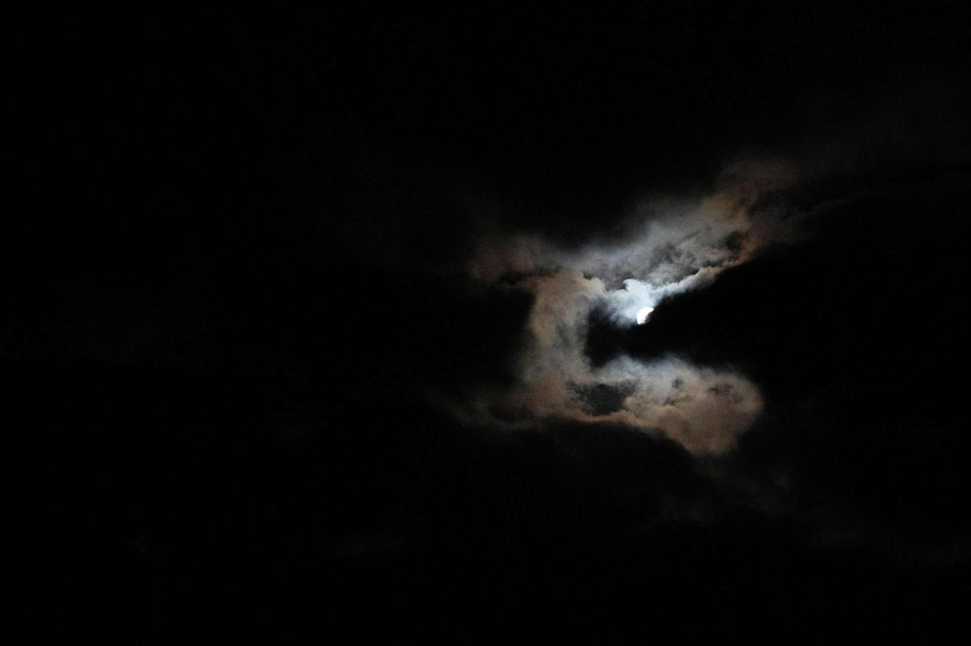 The Snow Moon over Aberdeen Beach, almost entirely obscured by clouds