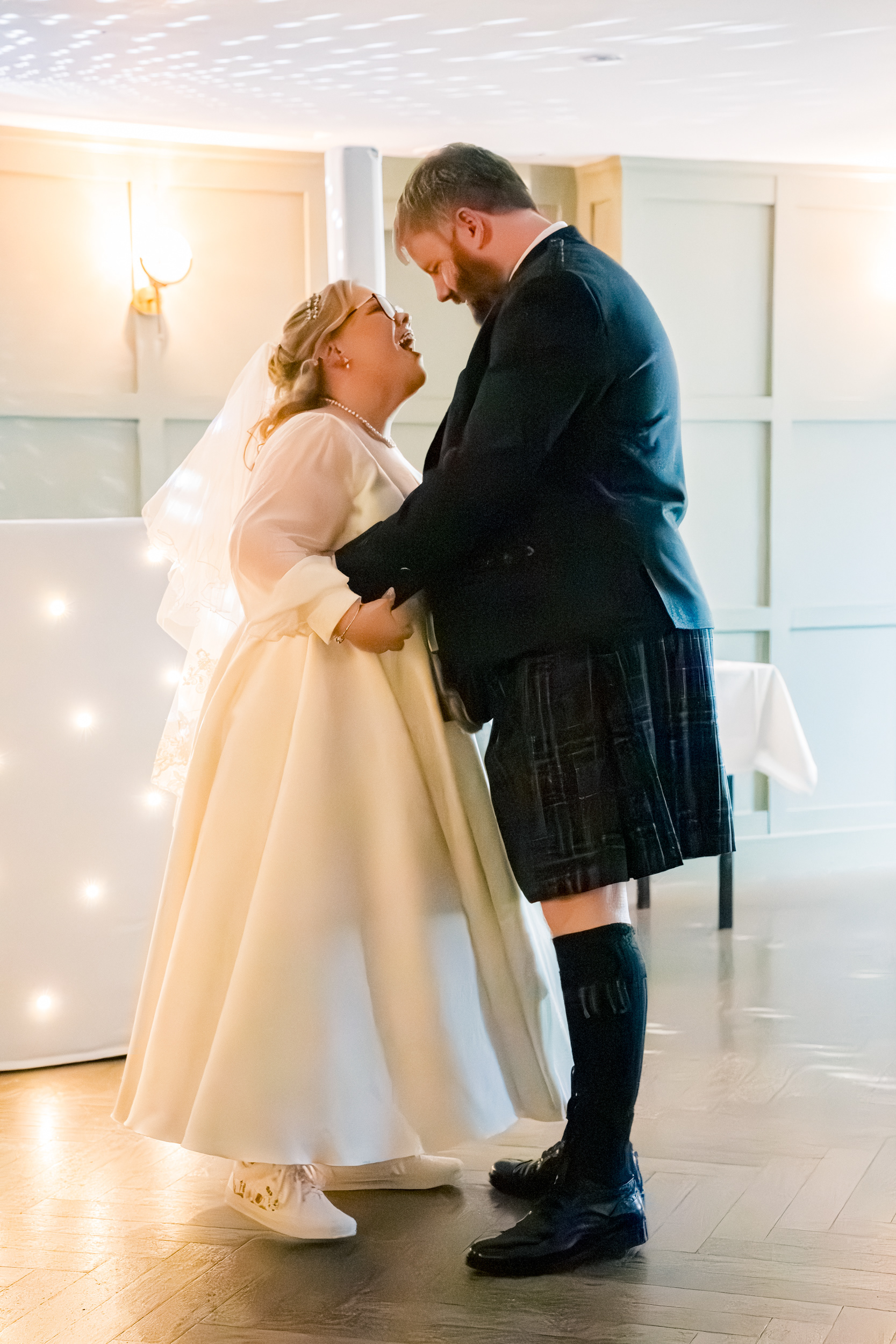 Aberdeen Palm Court wedding: Bride and groom laugh during first dance.