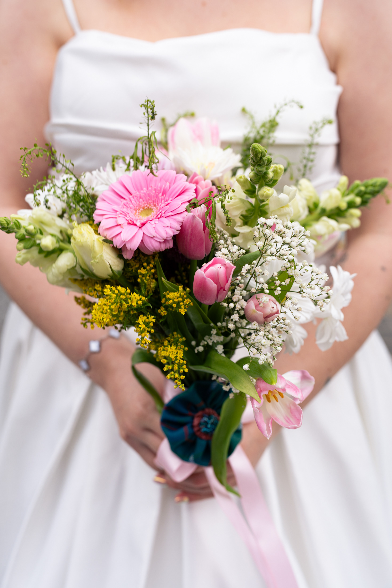 Detail shot of bride's DIY bouquet with pink flowers.