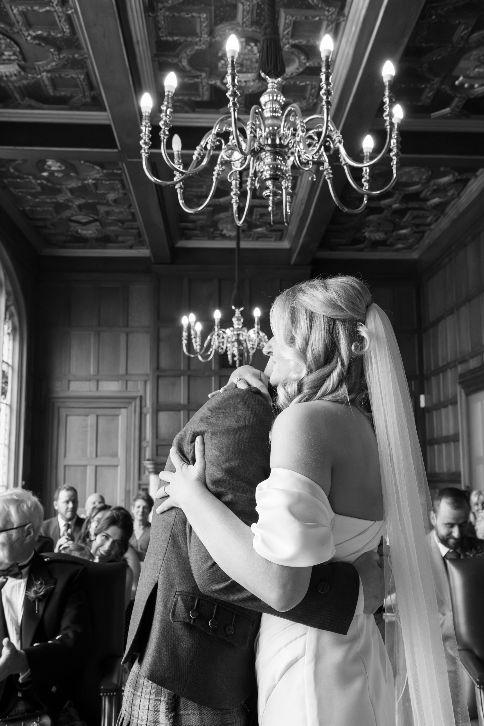 Aberdeen registry office wedding: Bride and groom embrace under the ornate ceiling at Marischal College.