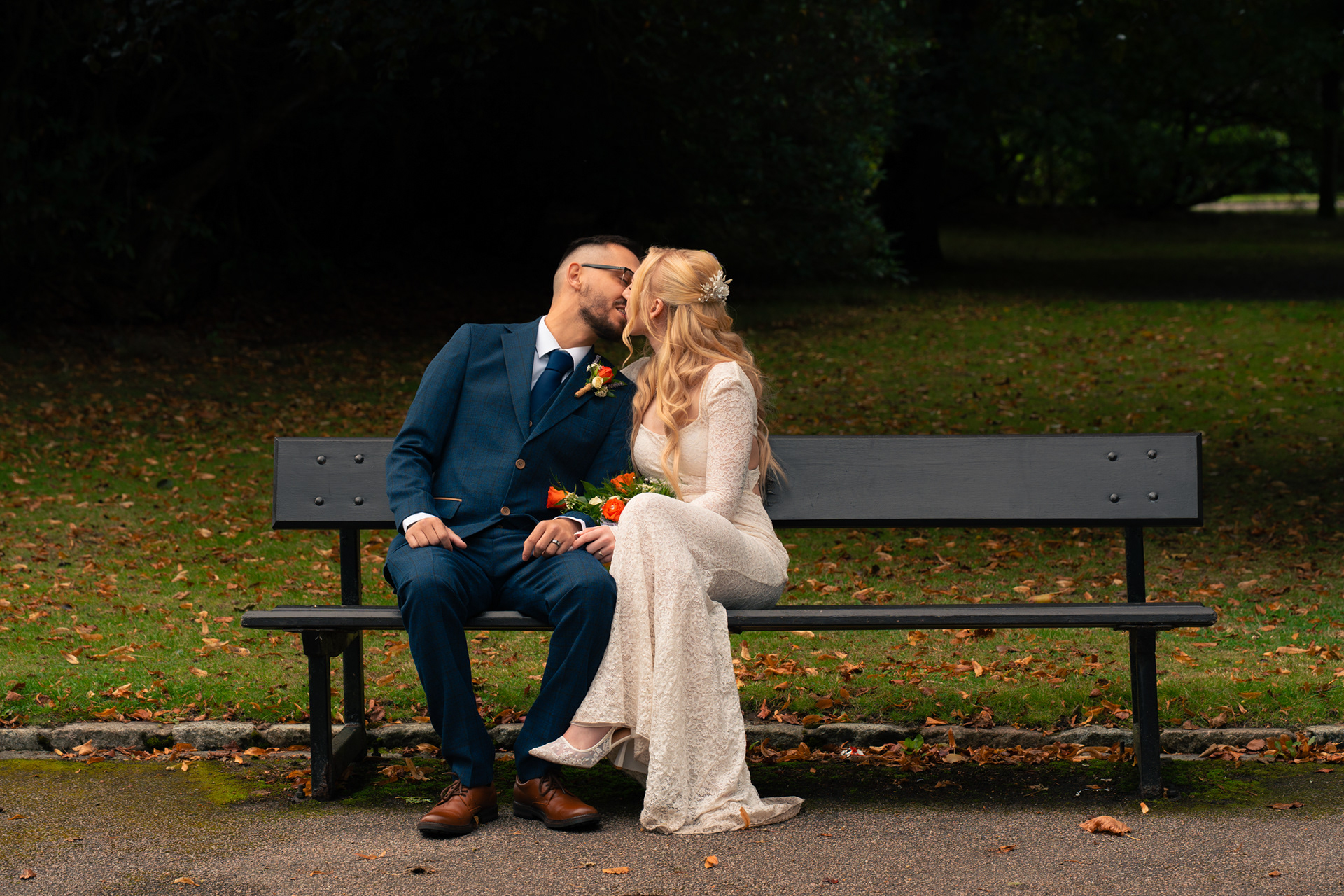 Duthie Park Winter Gardens wedding: Couple kiss on the bench where they spent their first date.