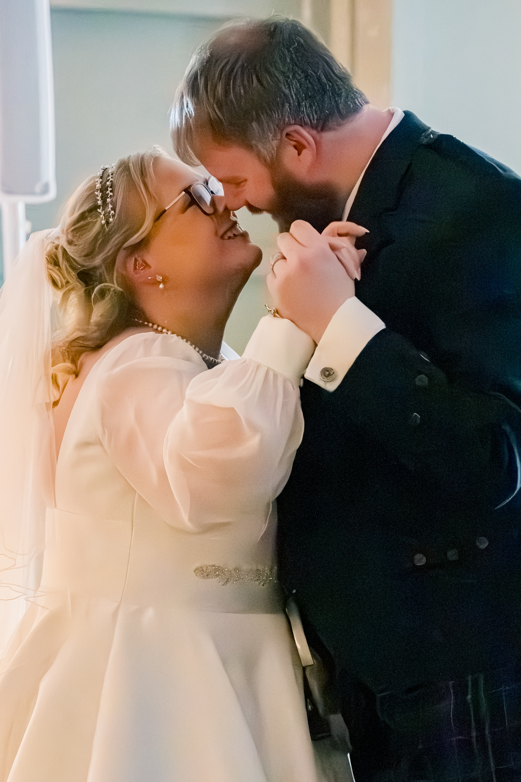Aberdeen Palm Court wedding: Close up of bride and groom about to kiss during their first dance.