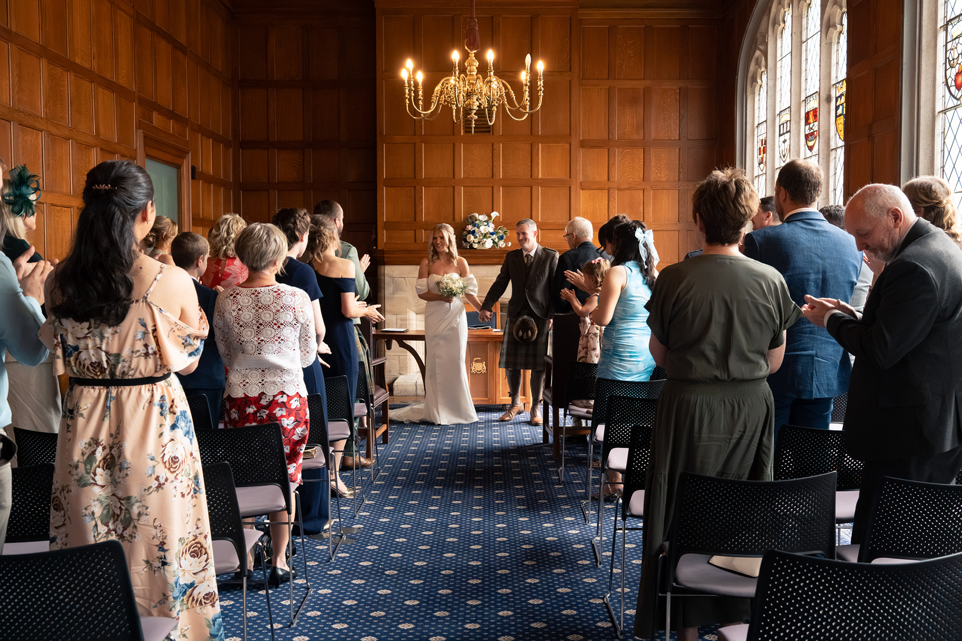 Marischal College wedding: Bride and groom prepare to walk back down the aisle as their guests applaude.
