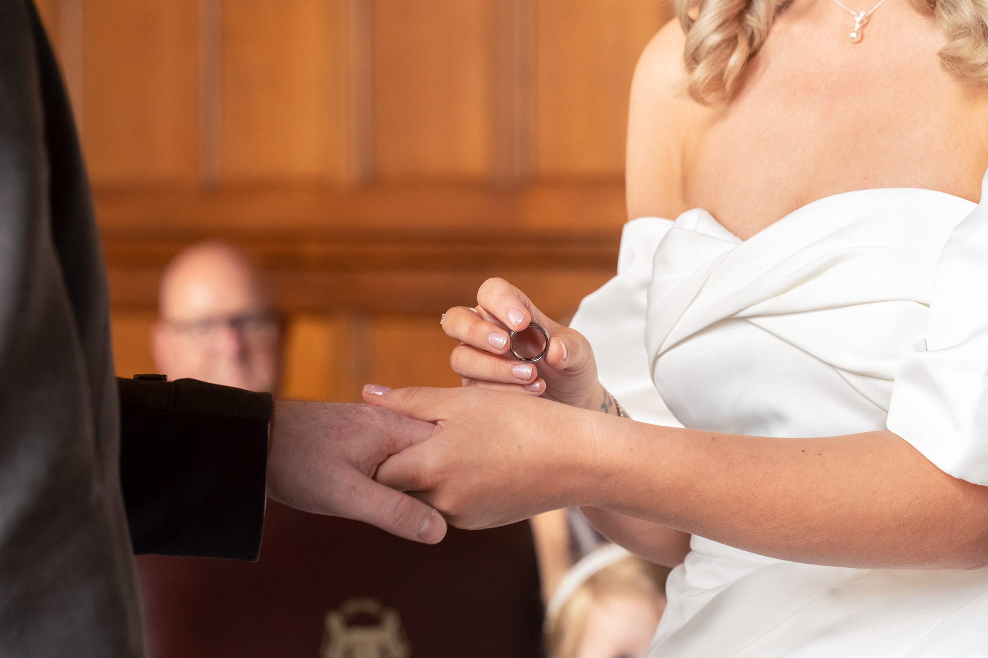 Aberdeen wedding photography: Close up of bride and groom's hands, held, bride holding the ring she is about to put on the husband-to-be's finger.
