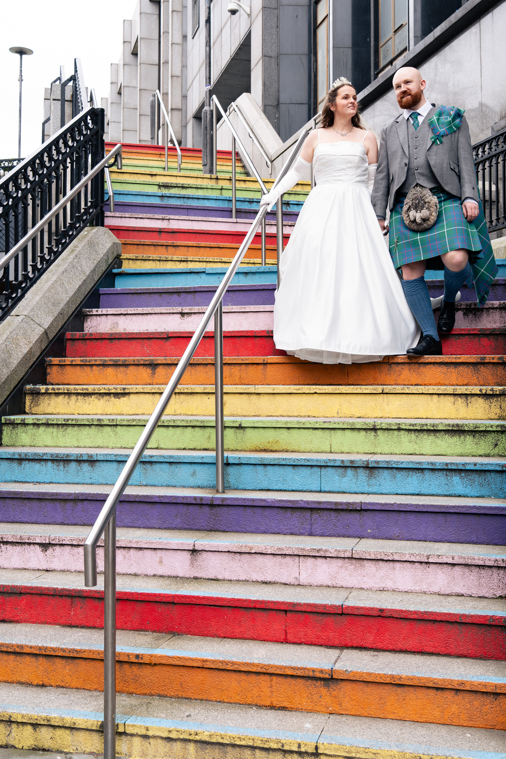 Alternative Aberdeen Wedding Photography: Newlyweds walk down the rainbow steps in Aberdeen city centre.