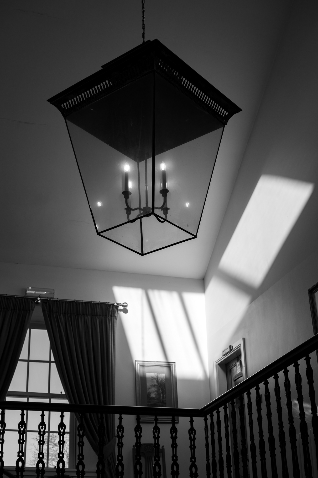 Logie Country House: Sunlight hits the ceiling of a stairwell, geometric lightshade perfectly placed to complement it