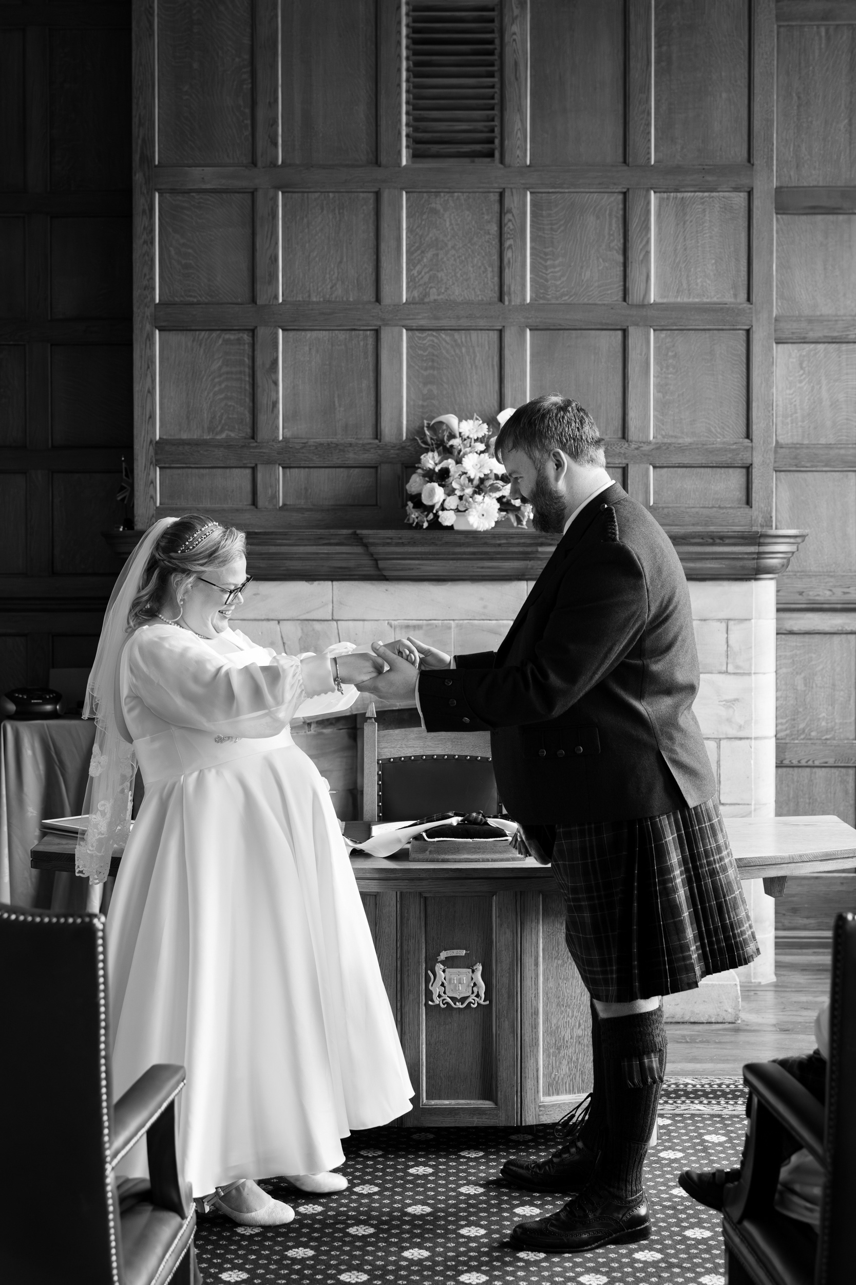 Black and white photo of bride and groom dancing during their Marischal College wedding.