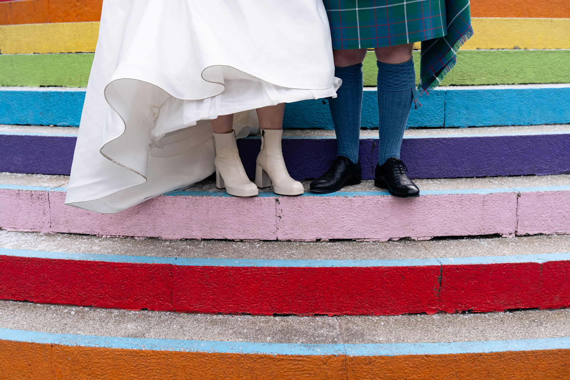 Alternative Aberdeen Wedding Photography:  Close up of bride's boots and groom's shoes on the rainbow steps in Aberdeen.