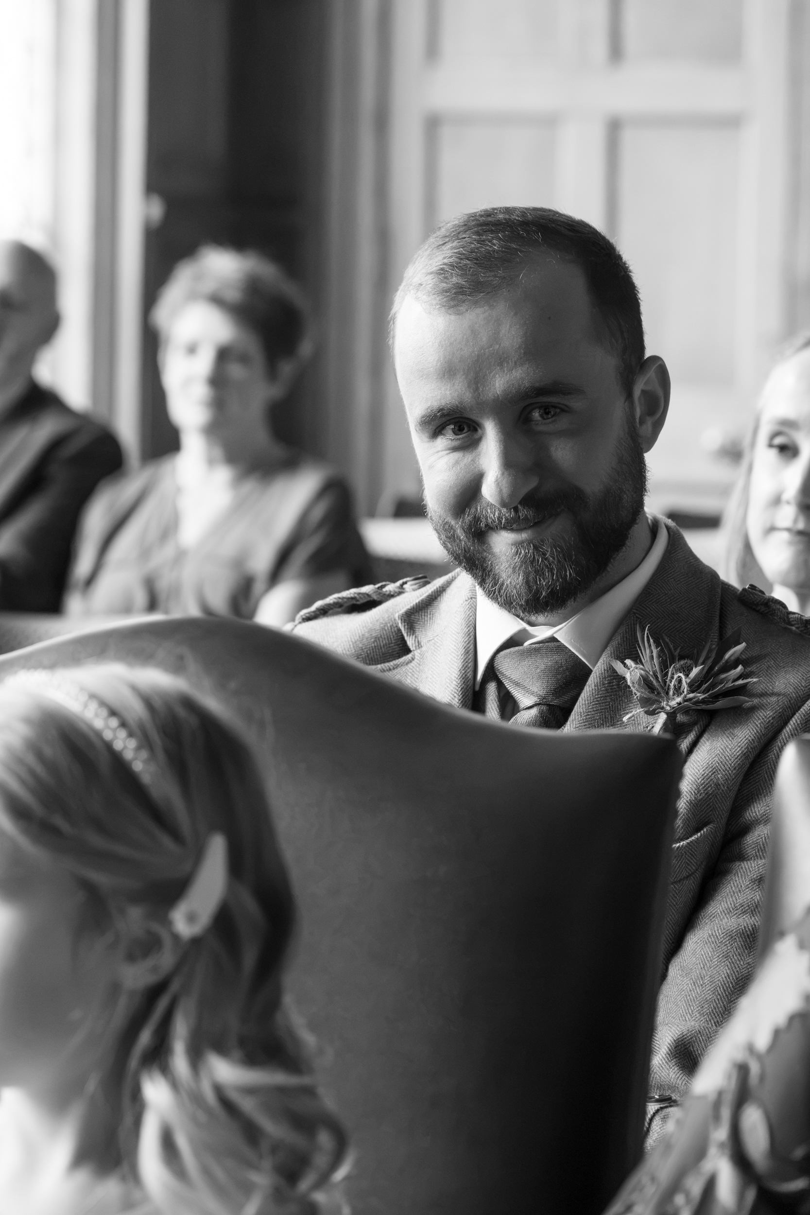 Aberdeen registry office wedding: Black and white photo of the bride's brother smiling.