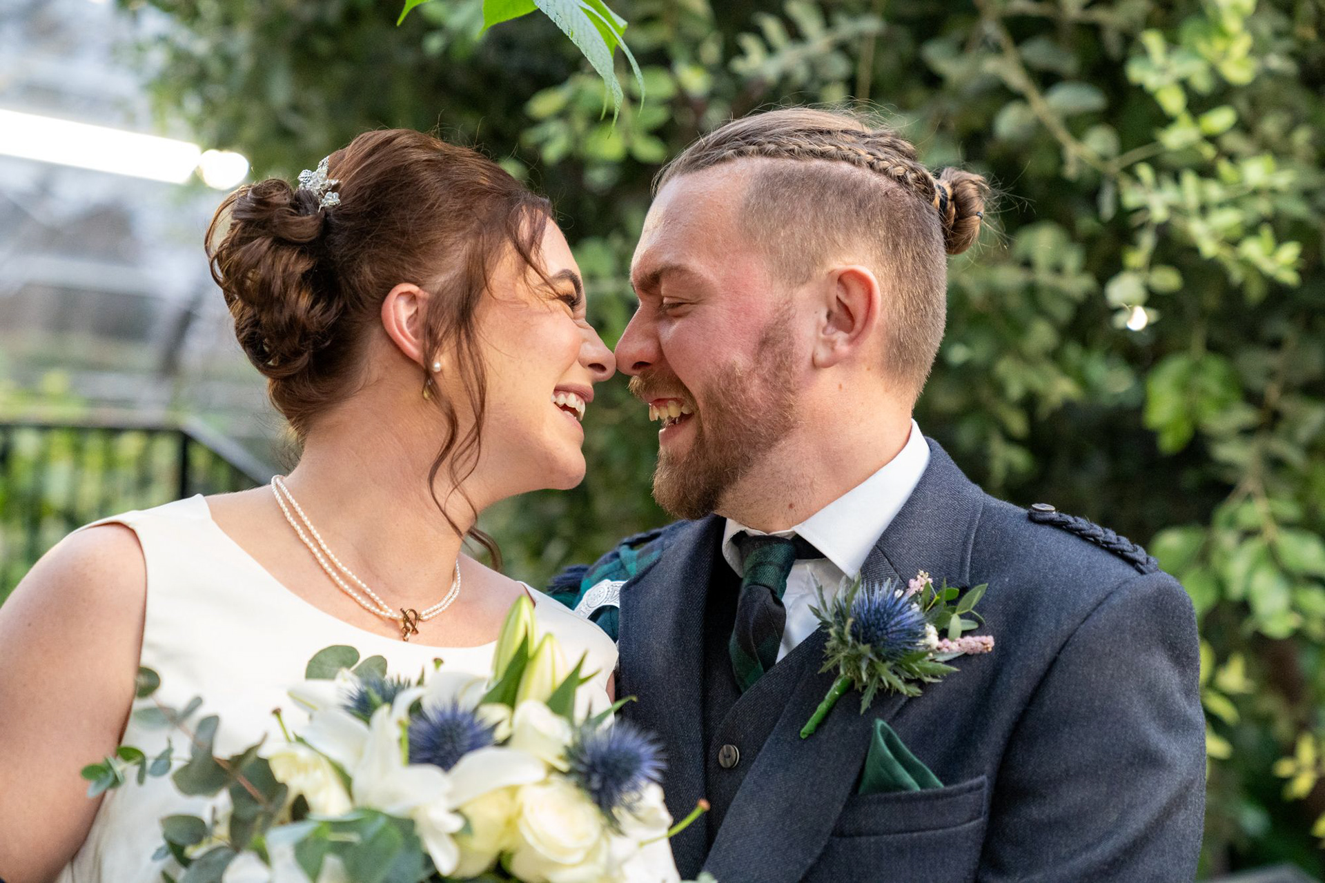 A newlywed couple laugh uncontrollably after their Winter Gardens wedding in Aberdeen.