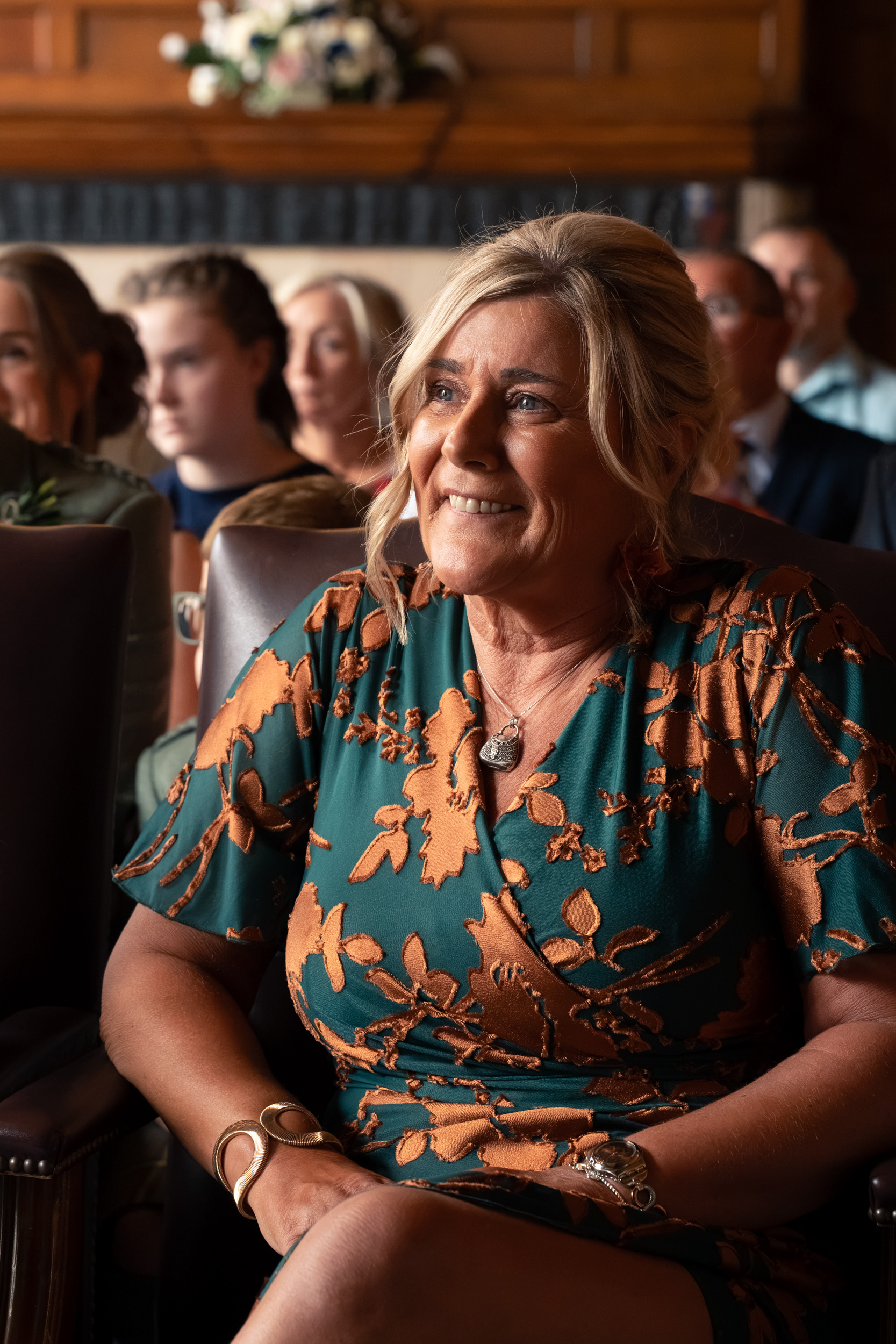 Aberdeen registry office wedding: Guest photo of a smiling mother in green and orange dress.