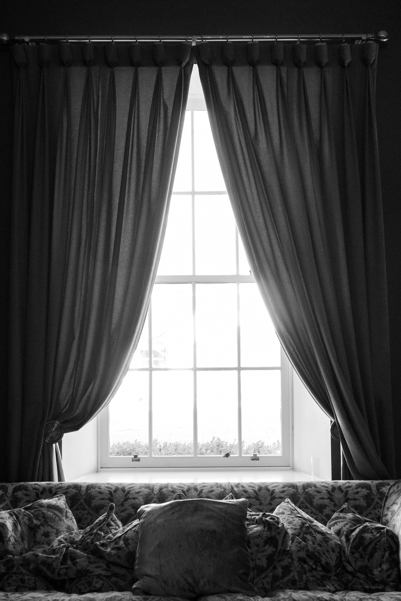 Logie Country House: Sunlight blows out the view through this sash and case window, with brocade sofa in front of it and thin curtains
