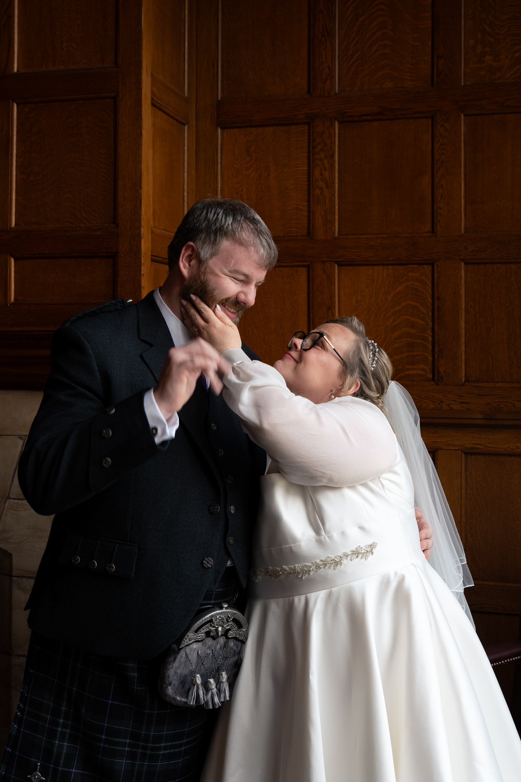 Aberdeen registry office wedding: Bride and groom laugh together at Marischal College.