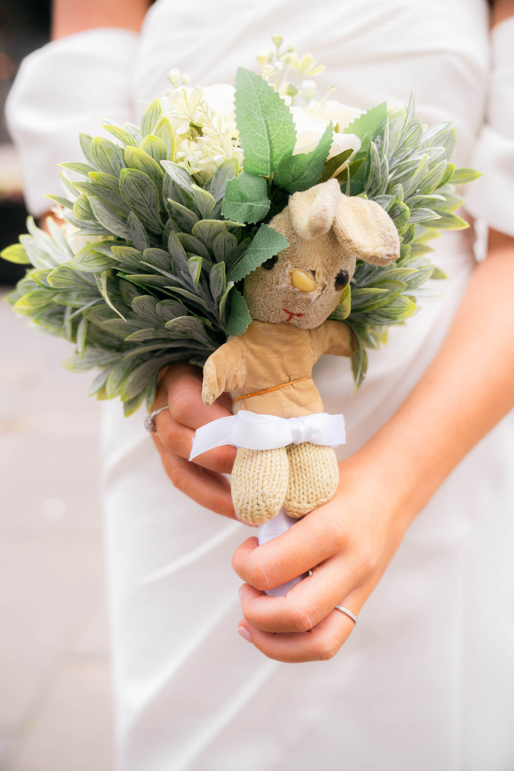 Aberdeen registry office wedding: Close up of bride's bouquet of white flowers with childhood bunny toy tied into the flowers.