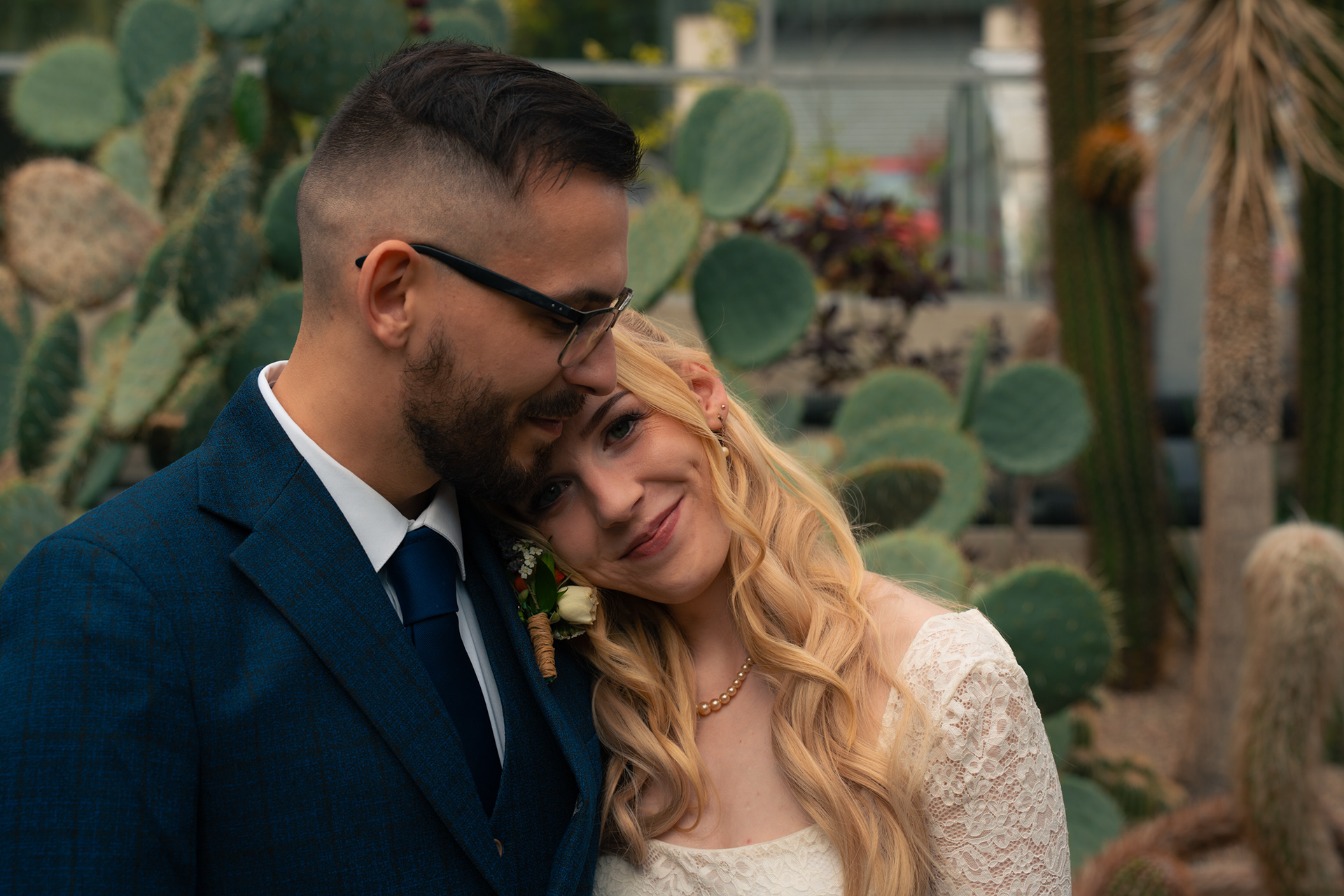 Duthie Park Winter Gardens wedding: Bride rests her head on her husband's shoulder in the cactus house.