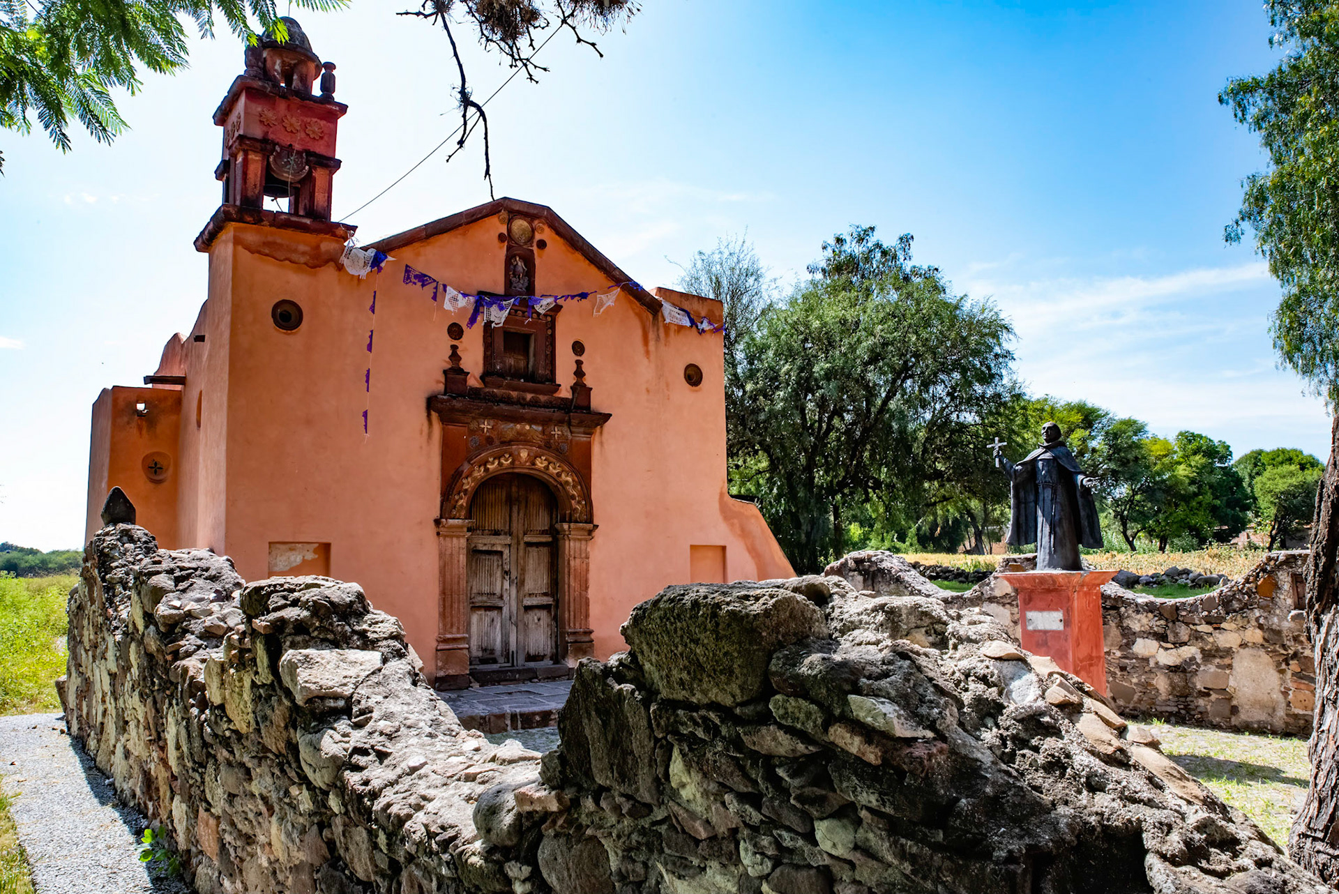 Stone wall and courtyard with Church of San Miguel VIejo, Mexico
