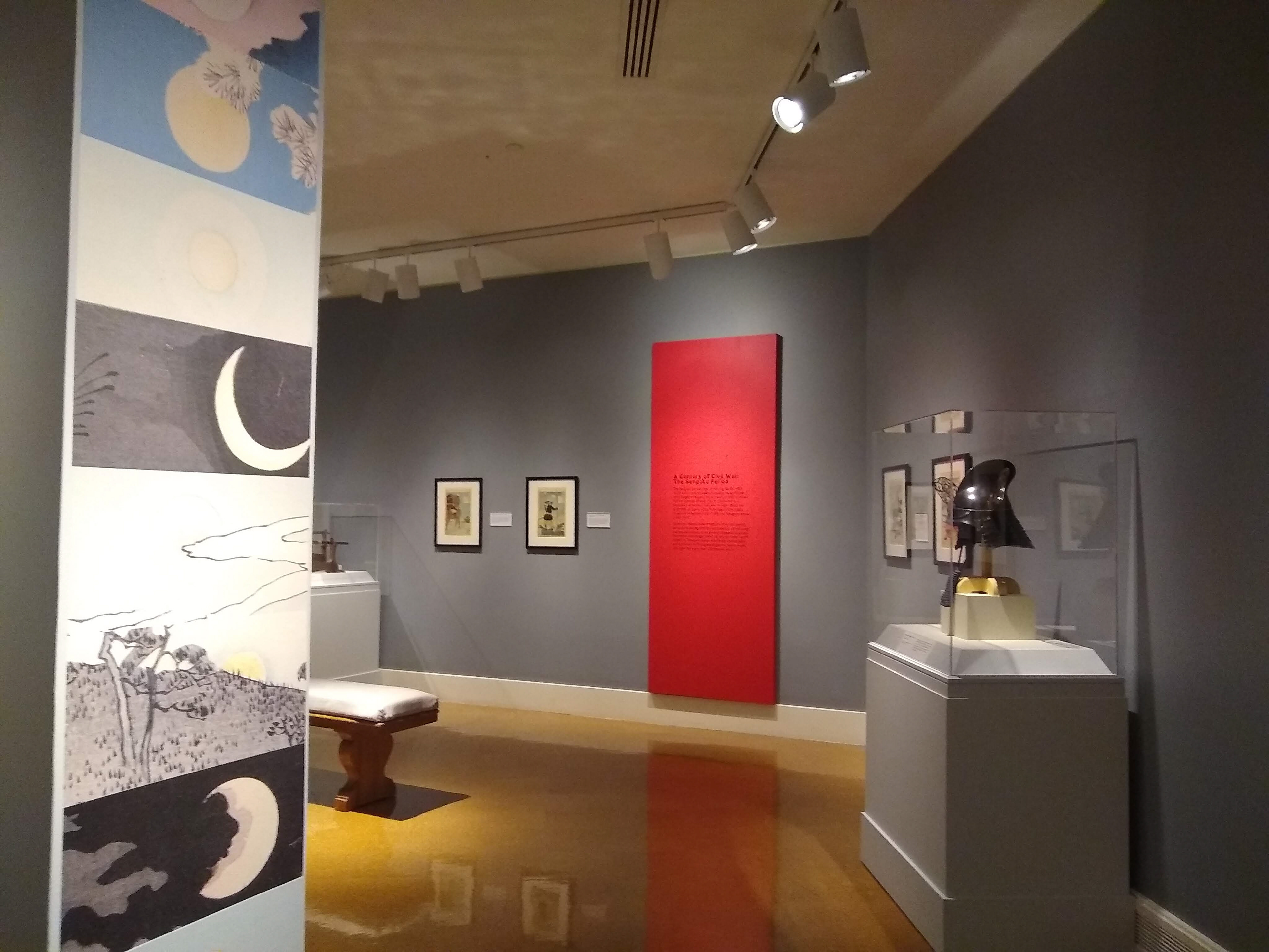 The collage of moons on the end caps of false walls were created by cropping images of the prints in the exhibition.
