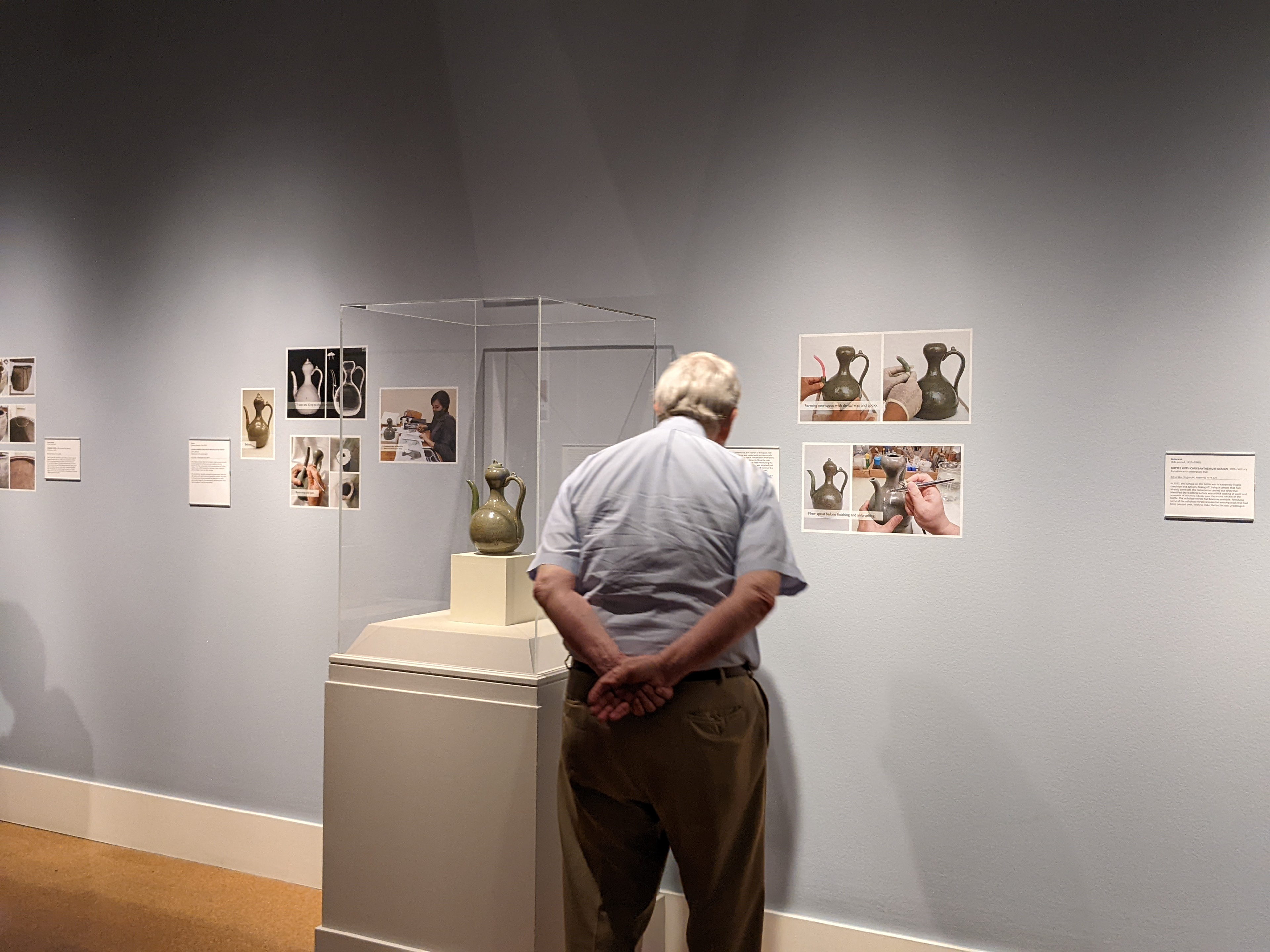 View of art work surrounded by the 'flair' or informational panels detailing the conservation process.