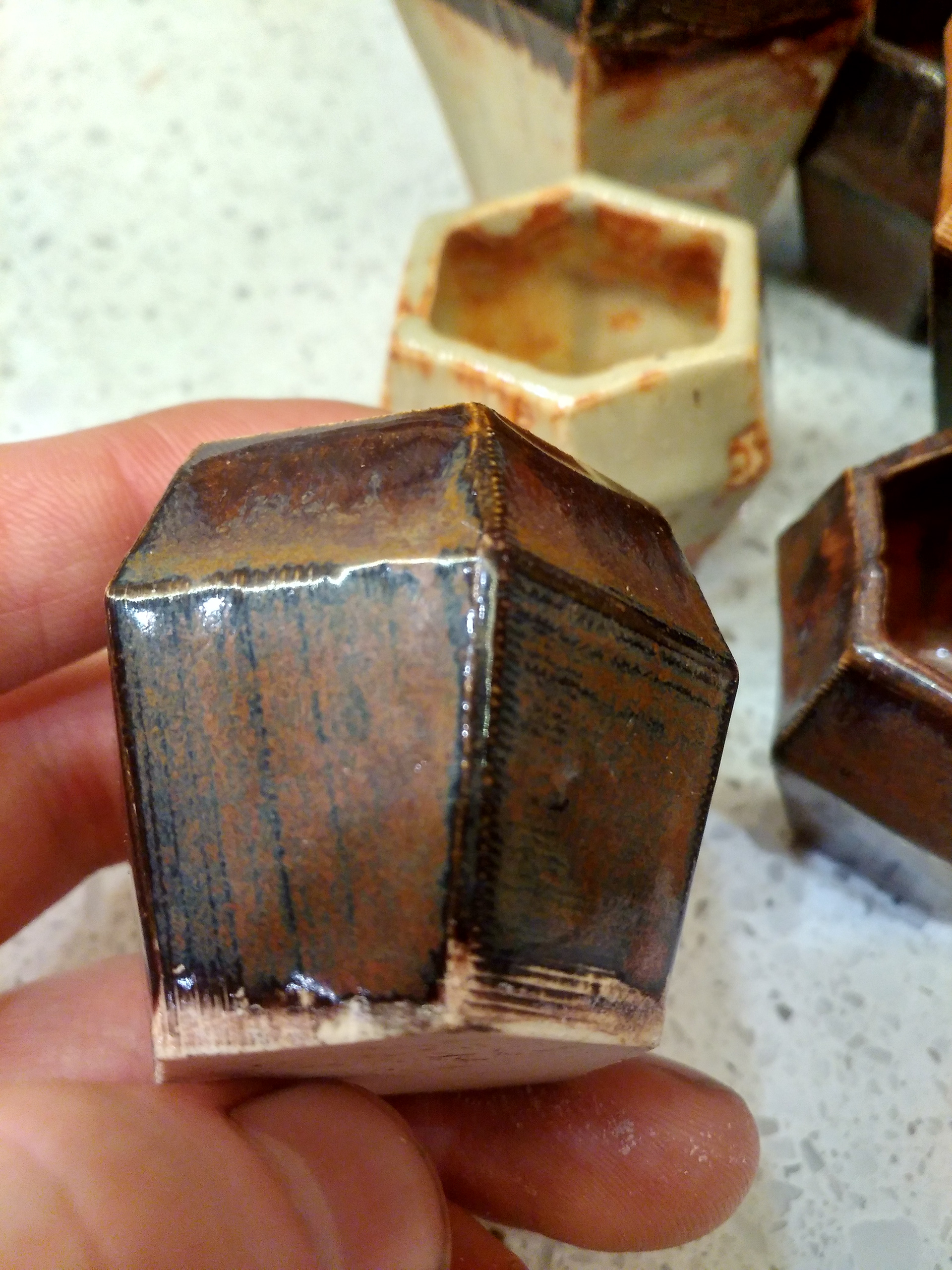 The color variations in the glaze is a natural process in traditional pottery.