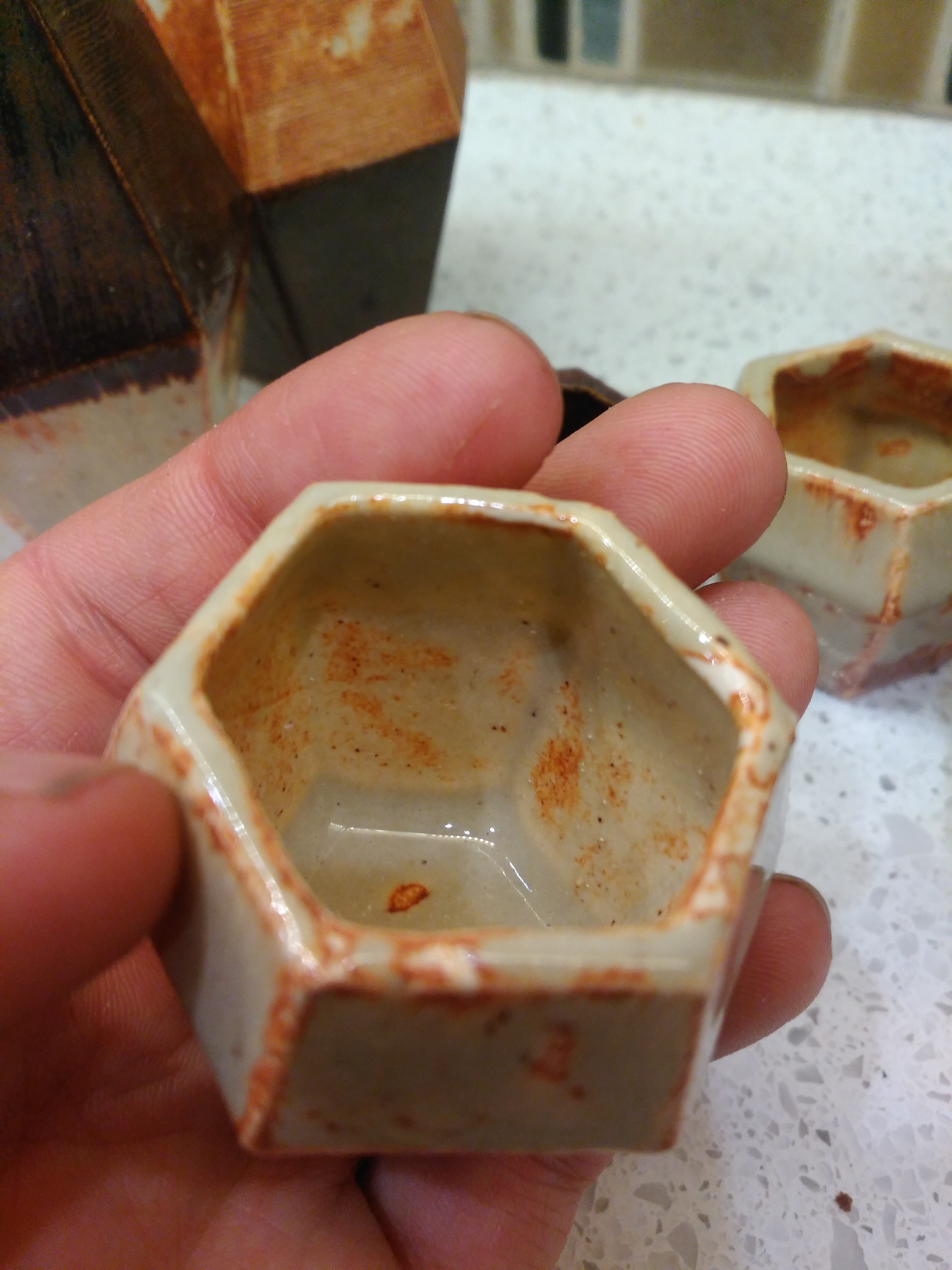 Notice how the molten Glaze pours down and hardens at the bottom of the cup.