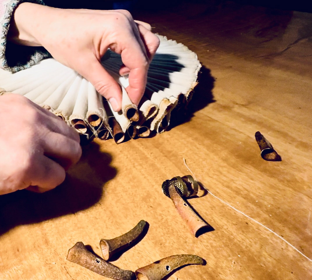 Sewing flower buds to collar frill