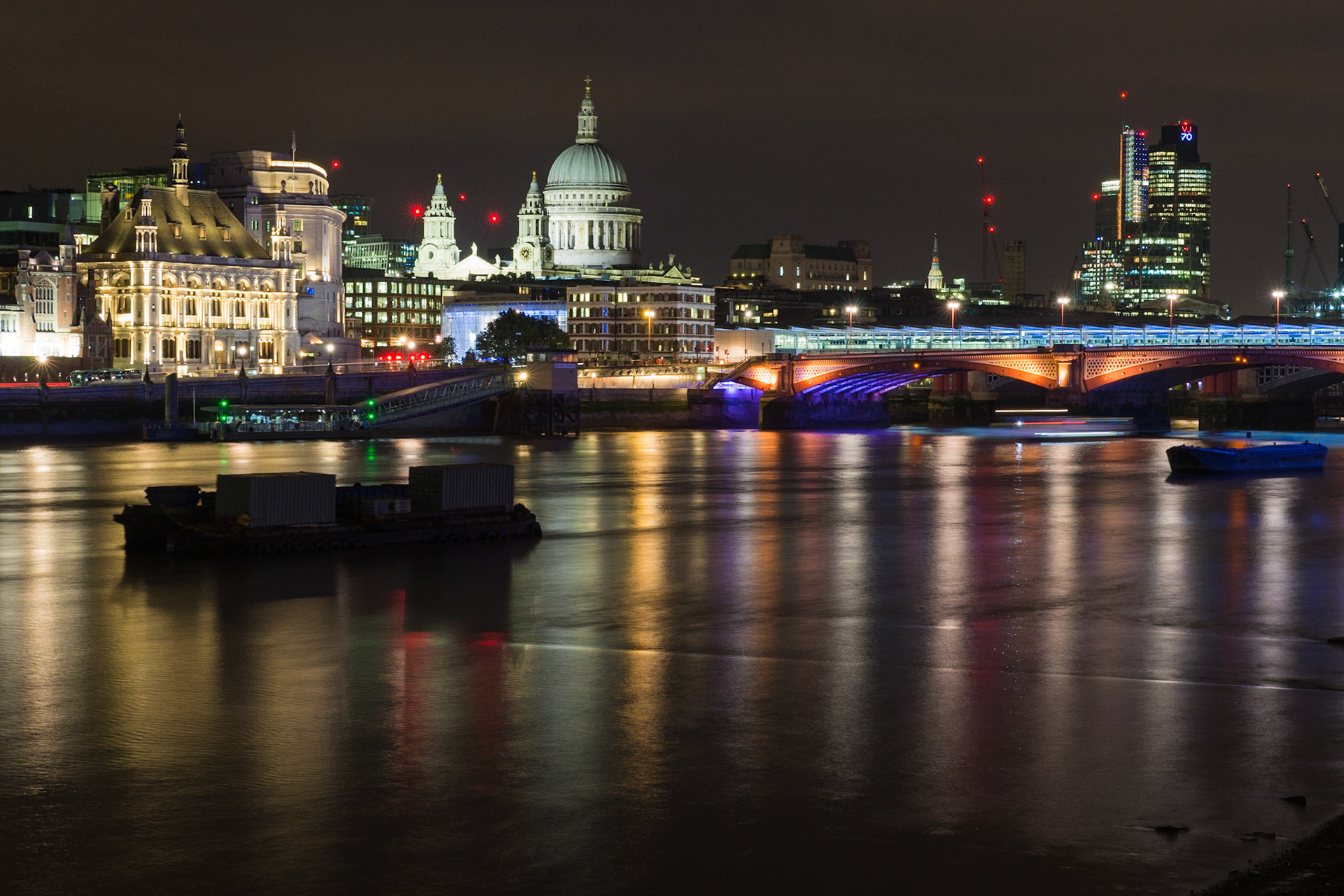 Dans le quartier de la City, la cathédrale St Paul's, chef d'oeuvre de Christopher Wren, se distingue par son dôme et ses deux tours baroques. A droite le Blackfriars bridge présente un éclairage variant de l'orange au violet.