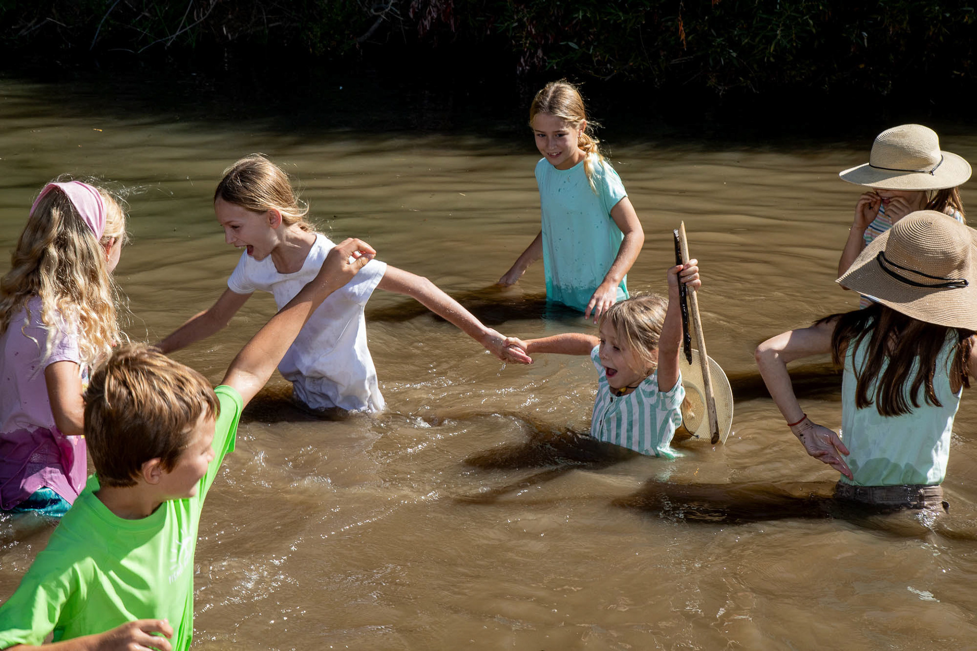 A group of local children play in a beaver pond in the waters of the Salinas River in Atascadero, California, United States. They reached the location guided by Audrey Taub, execute director of the Beaver Brigade. By the end of the dry season the Salinas River is usually at a low water level or completely dry, but in this location, there is water year-round due to the beaver dam. September 26, 2024.