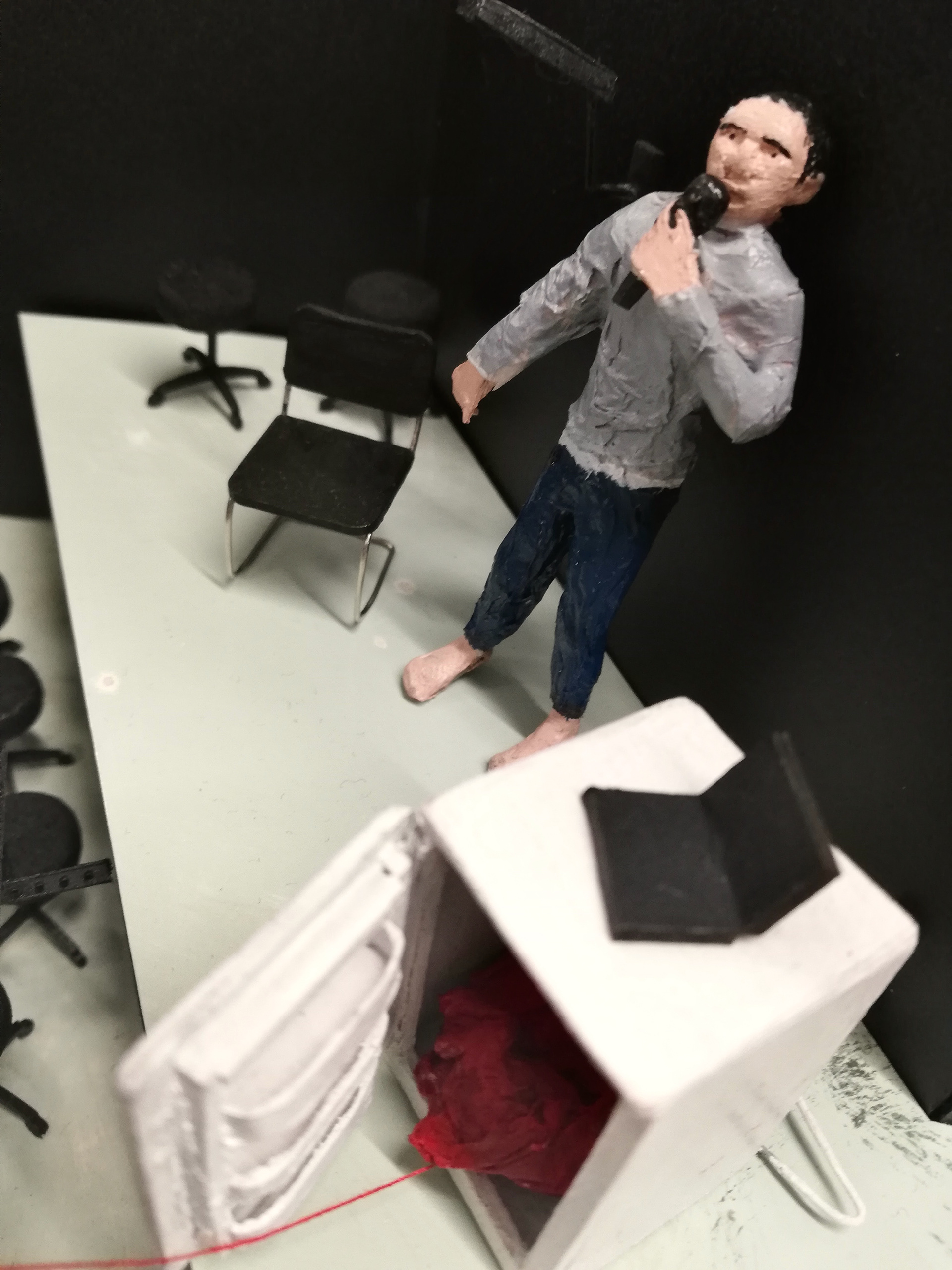 Xiang Lin narrates the play from the raised stage