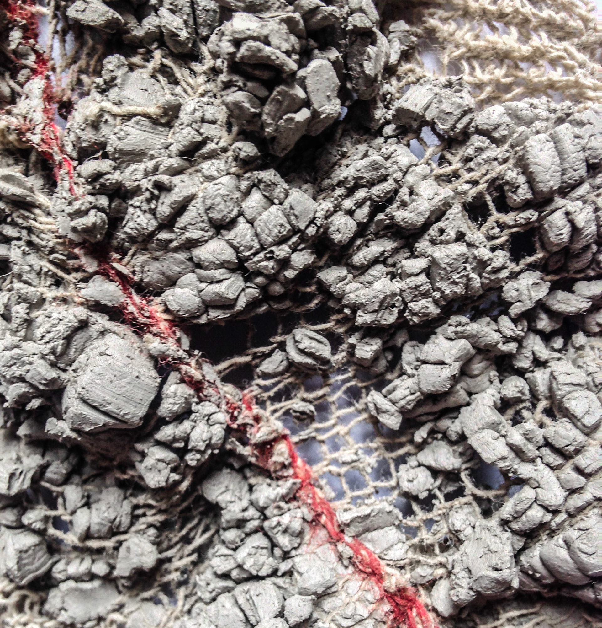 Close up of clay pushed through rag