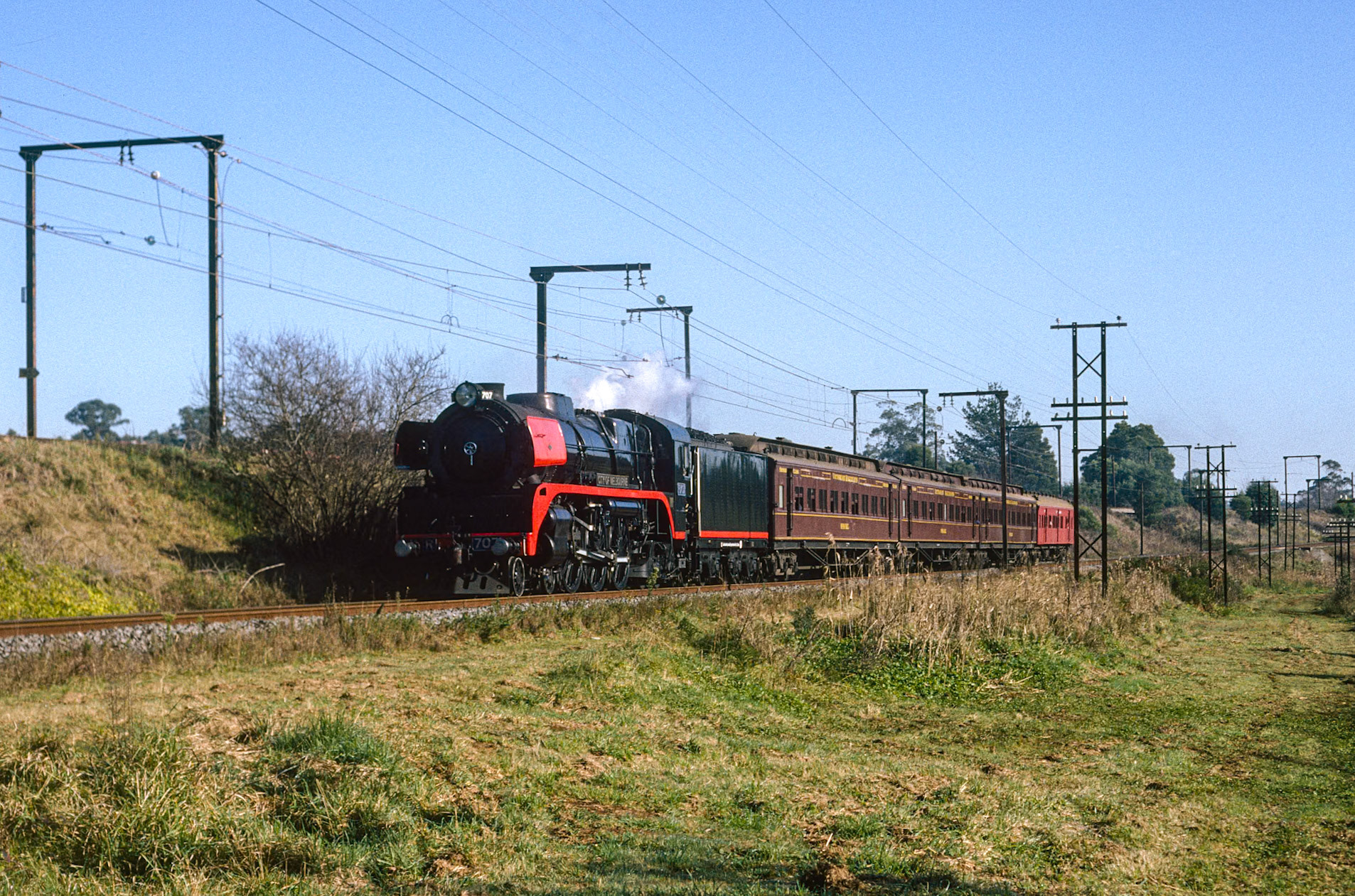 R707 coasts into Warragul with the ARHS "Coalie" tour to Traralgon. After a spin on the turntable at Traralgon, the train made a brief stop at Morwell to pick up a rake of seven GY wagons loaded with coal briquettes: at Dandenong the GYs were shunted into a siding, the briquettes destined for the furnaces at the nearby Heinz factory. The briquette trains stopped in 1996, and after a fire in 2003 the factory limped along at reduced capacity until finally closing in 2014. Beyond the fact that this was likely the last genuine mixed train to operate in Victoria, the other point of significance is this photo is from the first roll of film I'd shot, at just 5 years old.