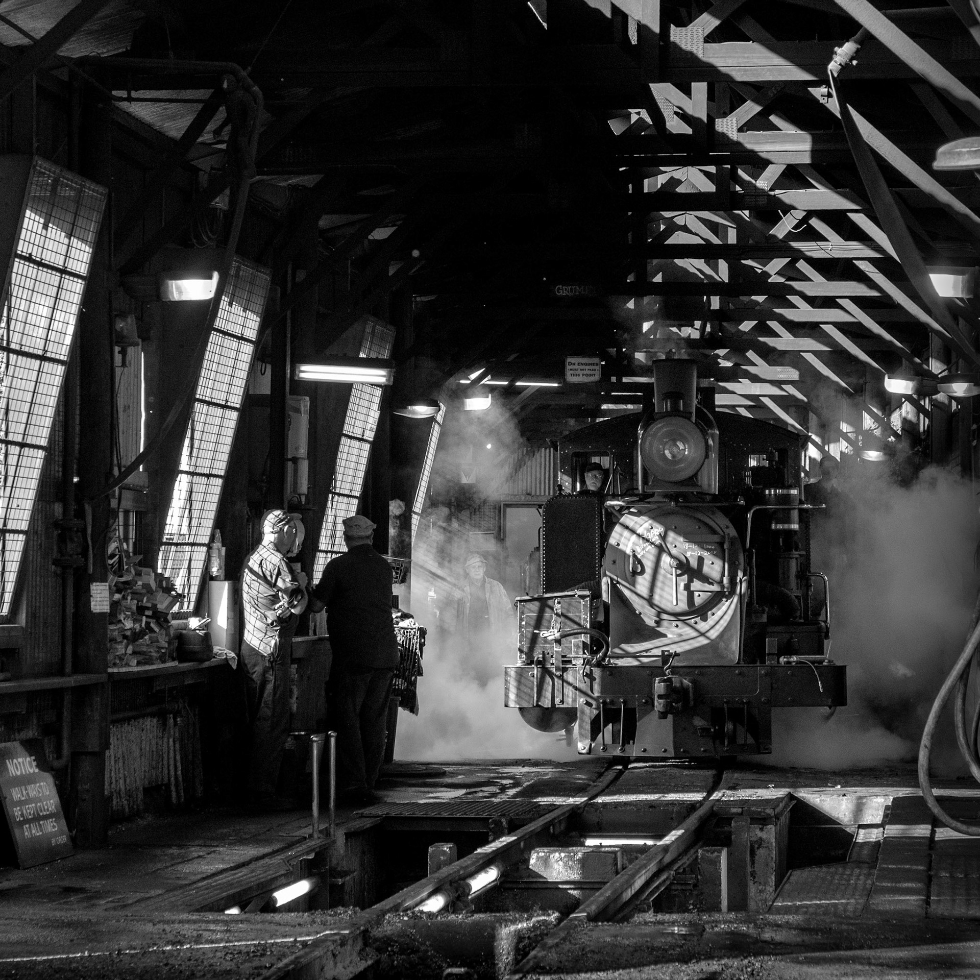 With early morning light pouring in through the windows, the crew of 8A propel it forward with a burst of steam towards the doors at the front of the running shed on the day of the railway's 119th birthday.