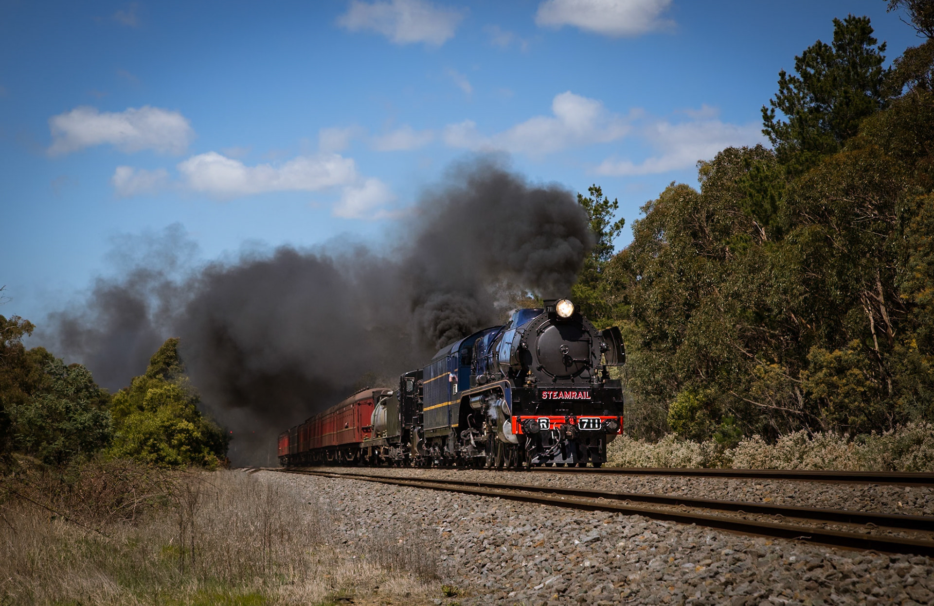 R711 and K153 roar through the outskirts of sleepy Macedon, as they race onwards to Castlemaine and a rollingstock transfer to the Victorian Goldfields Railway.