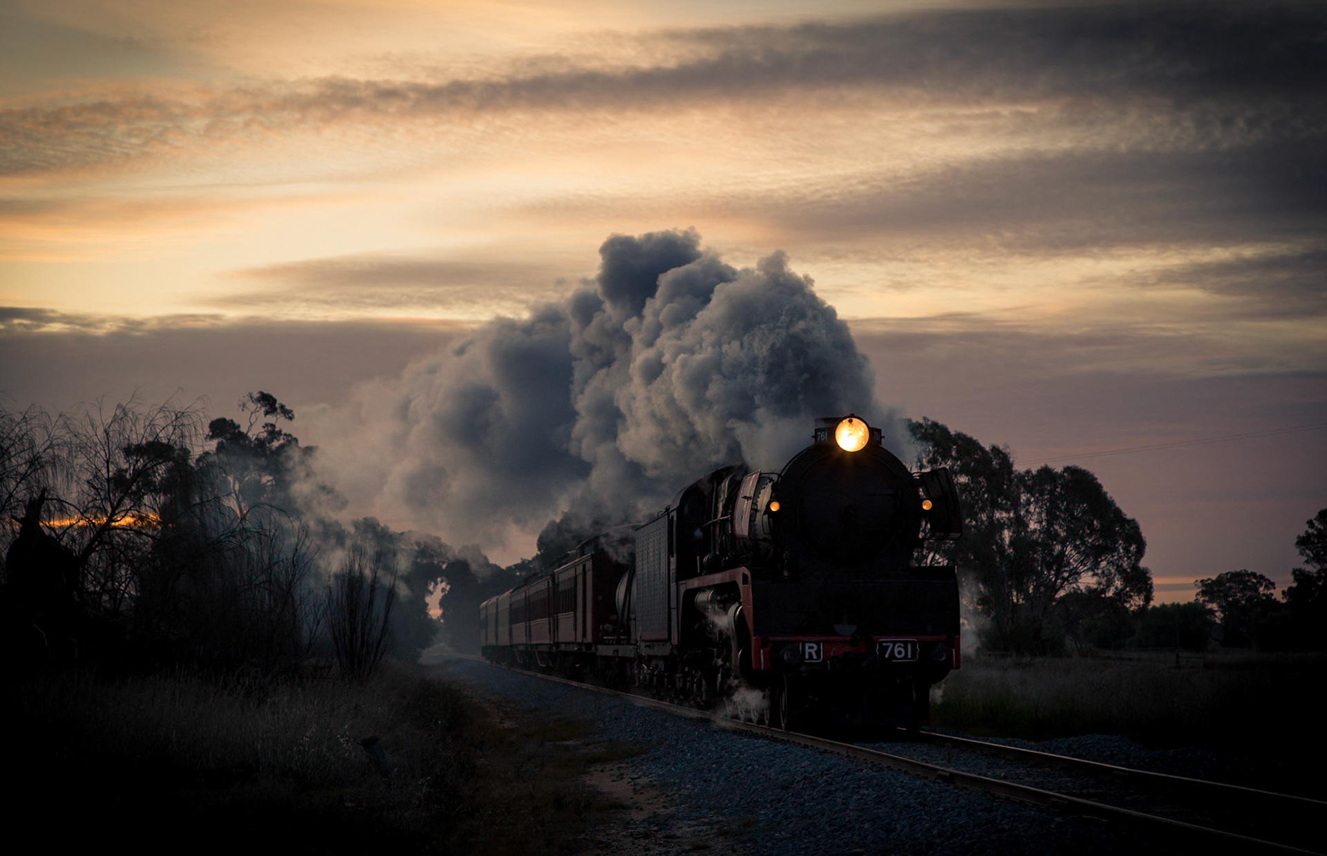 Just off the Midland Highway, near Tatura, R761 races to escape the setting sun as it drives relentlessly onwards to Melbourne with the return of Steamrail's Echuca Explorer tour train.