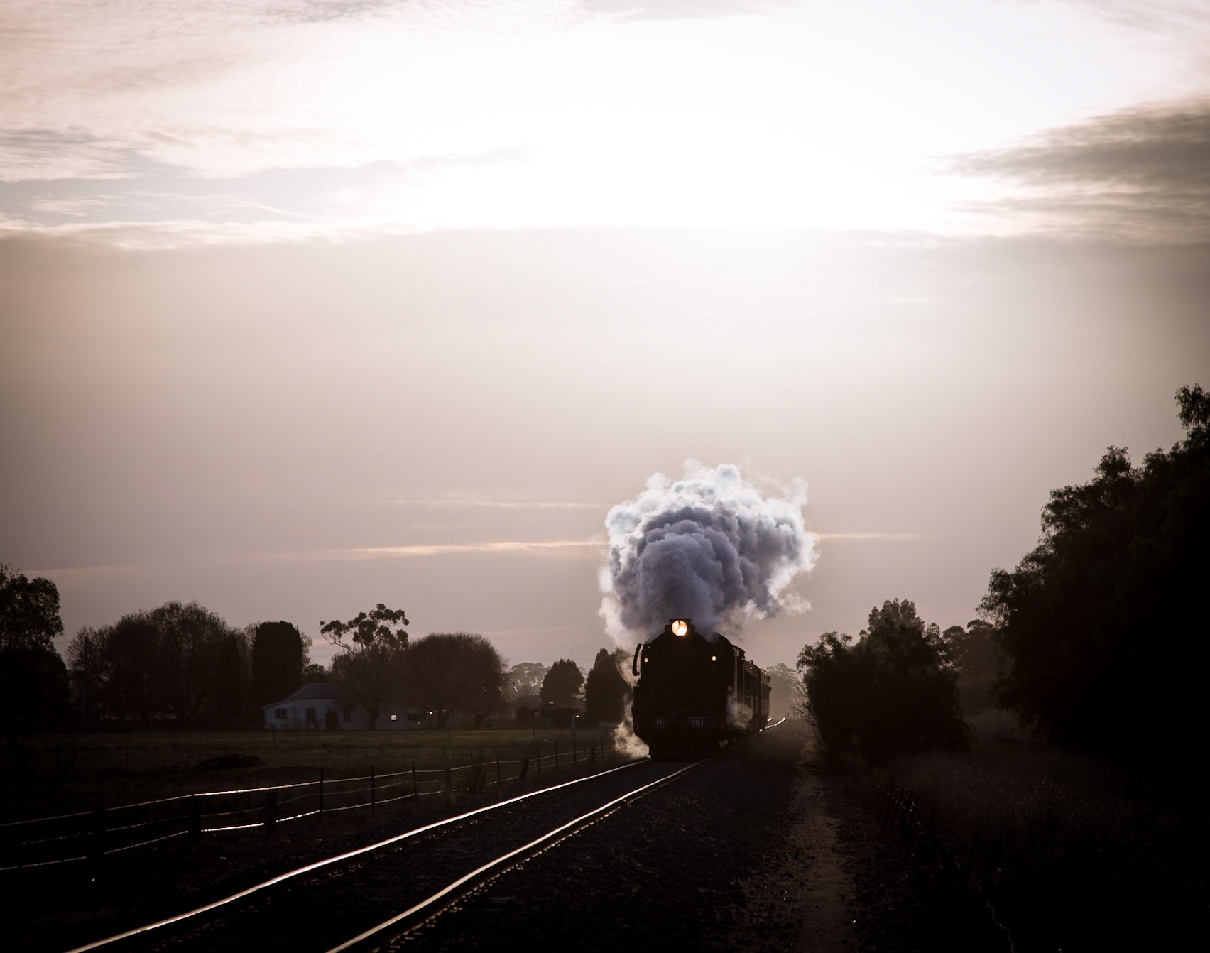 As the sun sets in the sky behind, casting glorious golden tones across the landscape, R761 roars towards Kyabram with Steamrail's Echuca Explorer tour train.