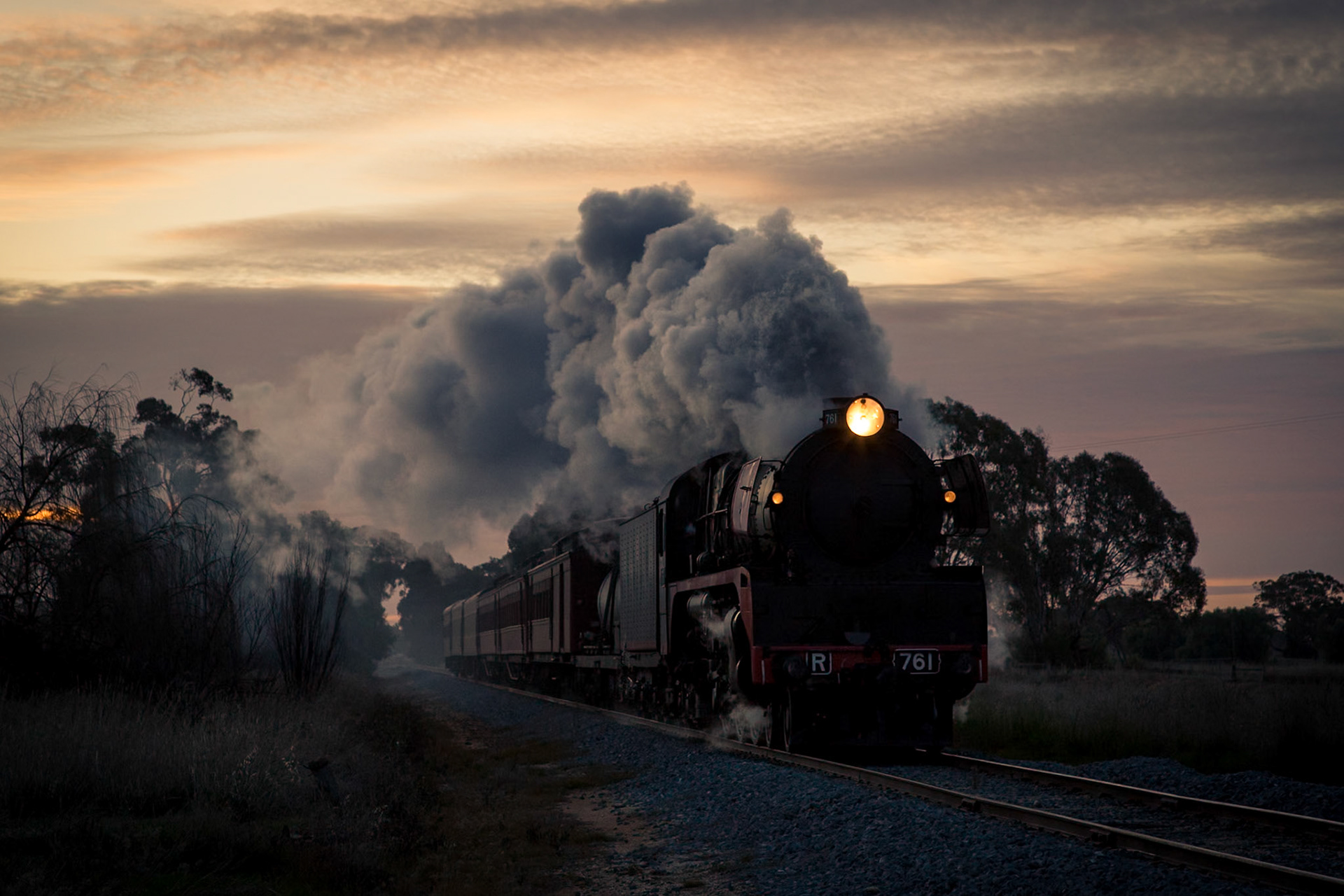 Just off the Midland Highway, near Tatura, R761 races to escape the setting sun as it drives relentlessly onwards to Melbourne with the return of Steamrail's Echuca Explorer tour train.