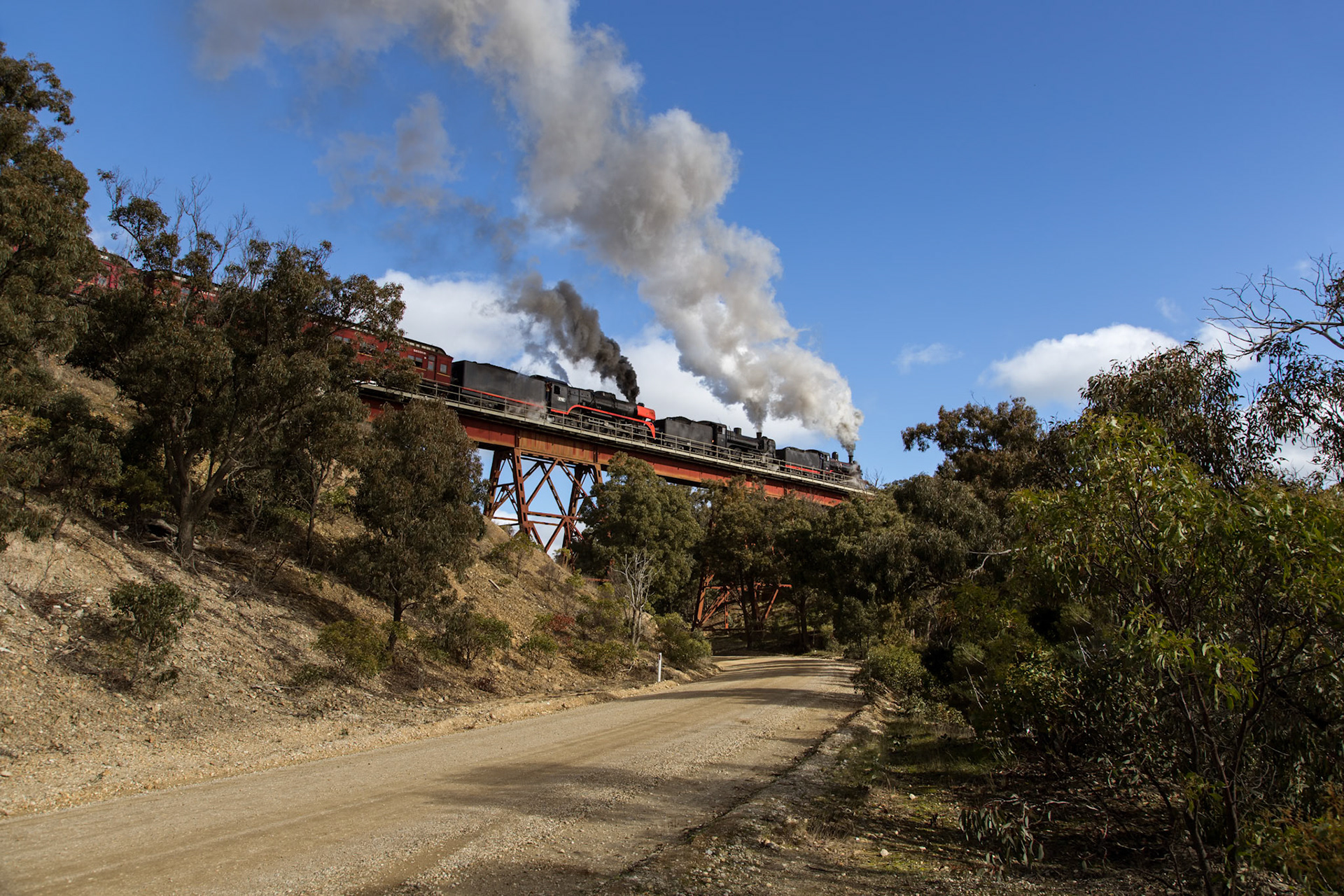 80 minutes after it should have arrived in Ballarat (some 45 kilometers away), Steamrail's D3 639, A2 986, and R761 storm across the Ironbark Gorge bridge between Bacchus Marsh and Ballan with Steamrail Victoria's "Steam Spectacular" tour through Western Victoria. A late departure from Southern Cross Station, pathing troubles, and a suffocated fire in the D3, all compounded to make this trip severely late. Despite - or perhaps, in spite of - all the delays and problems the heritage volunteers, V/Line, and RTBU, all worked together to keep the tour running as best to plan, and deliver the promised parallel run later that evening between Geelong and Lara.
