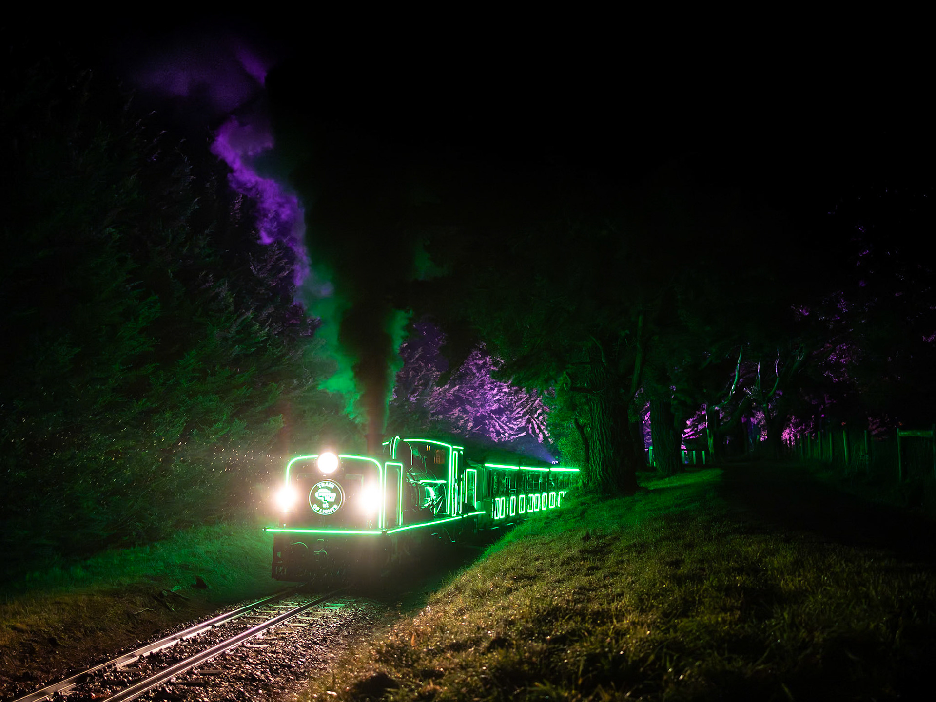 After struggling up the long climb from Cockatoo on wet rails, Puffing Billy's "Train of Lights" train crests the grade at Orchard Road on the outskirts of Gembrook.