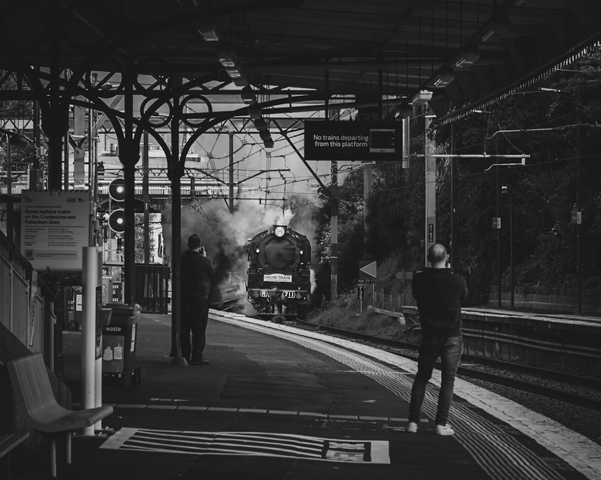 Enthusiasts watch on as R711 and R761 erupt below Cromwell Road overpass on the outskirts of Hawksburn station with the 2023 Snow Train.