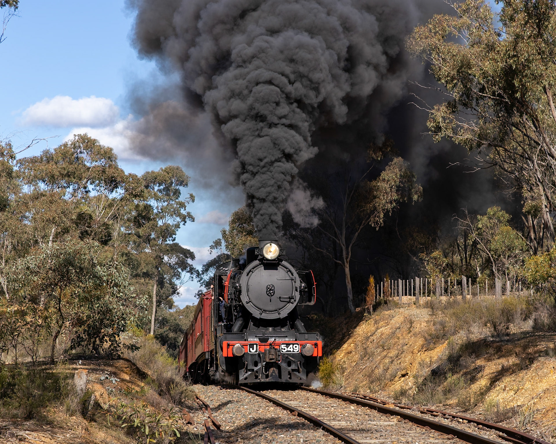 Climbing out of Castlemaine under warm winter skies, J549 exits the thick bushland of Walmer State Forest at Boundary Track and starts rolling descent towards Muckleford.