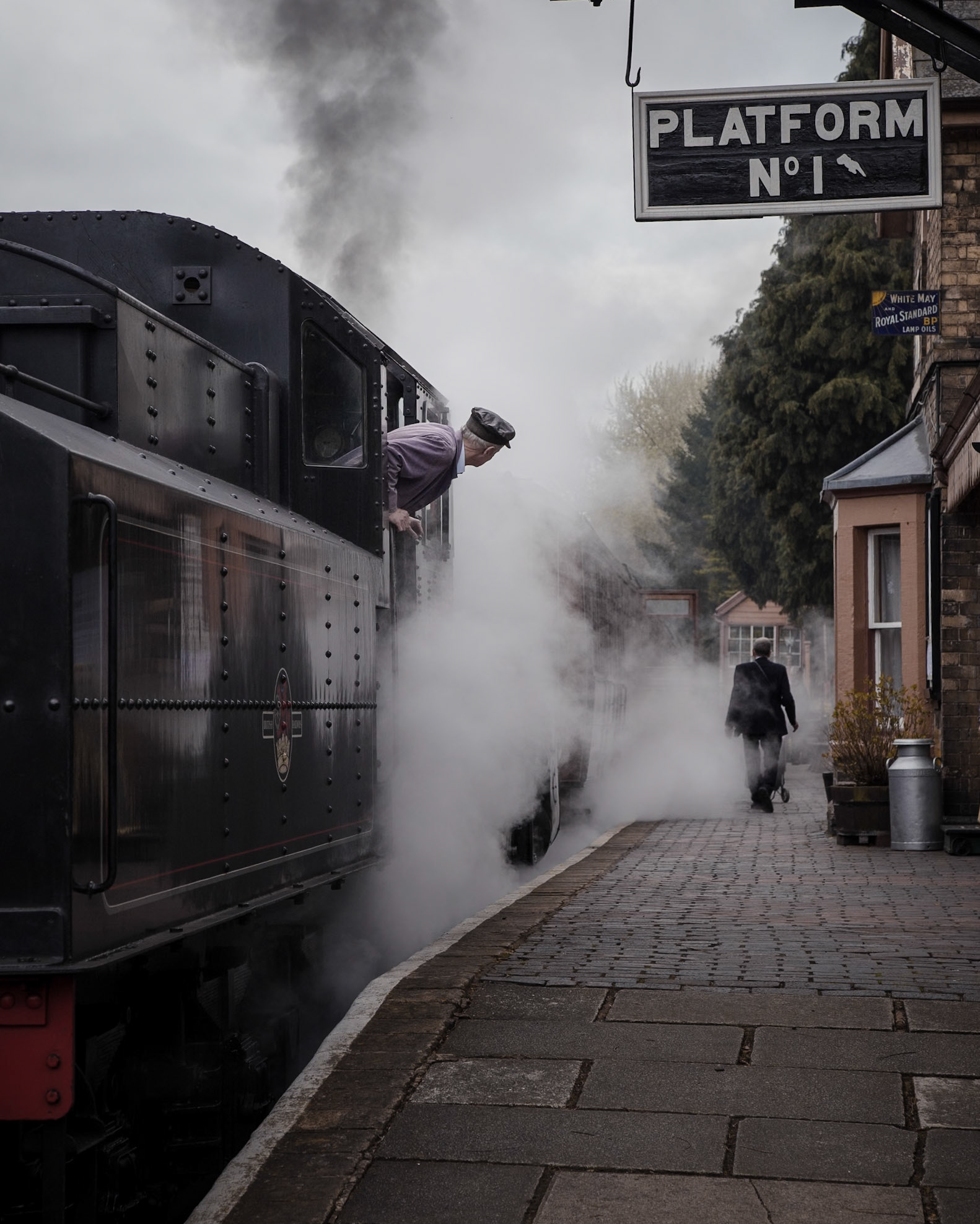 The fireman of the Ivatt Class 4 no. 43106 - the only survivor of a class of 162 locomotives - waits for the guard to check his train before leaving Hampton Loade for Bridgnorth, on the stunning Severn Valley Railway in England's West Midlands.