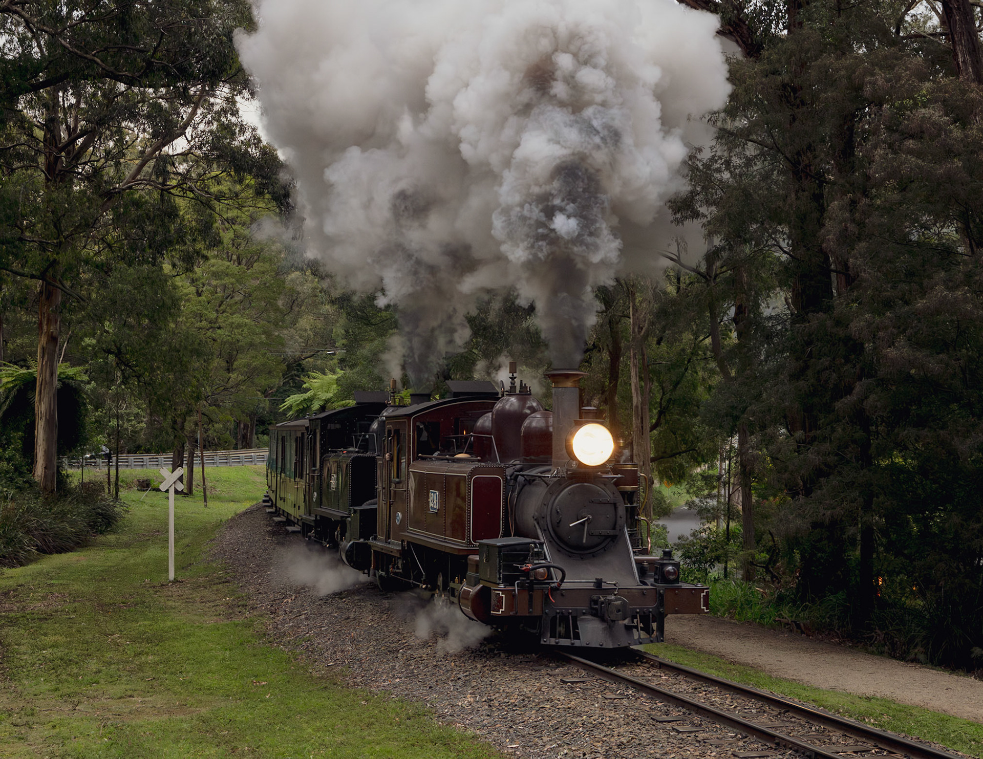Running 40 minutes late and with sunlight fading fast behind the evening stormclouds, 12A and 8A start the climb uphill from Clematis to Emerald on their way through to Gembrook. The two NAs were transferring carriages to Gembrook ahead of the following day's Kids Fun Run event.