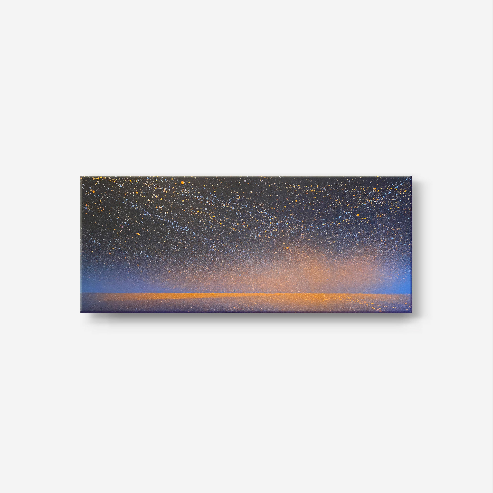 A panoramic night landscape painting showcasing a star-dusted sky above a flat horizon line. The abstract composition balances a dark blue and black textured background with warm, glowing accents. Thousands of delicate white, light blue, and orange paint droplets scatter across the night sky, while a soft, atmospheric orange and ochre haze rises from the bottom right, reflecting as a clean horizontal line that highlights an empty road.